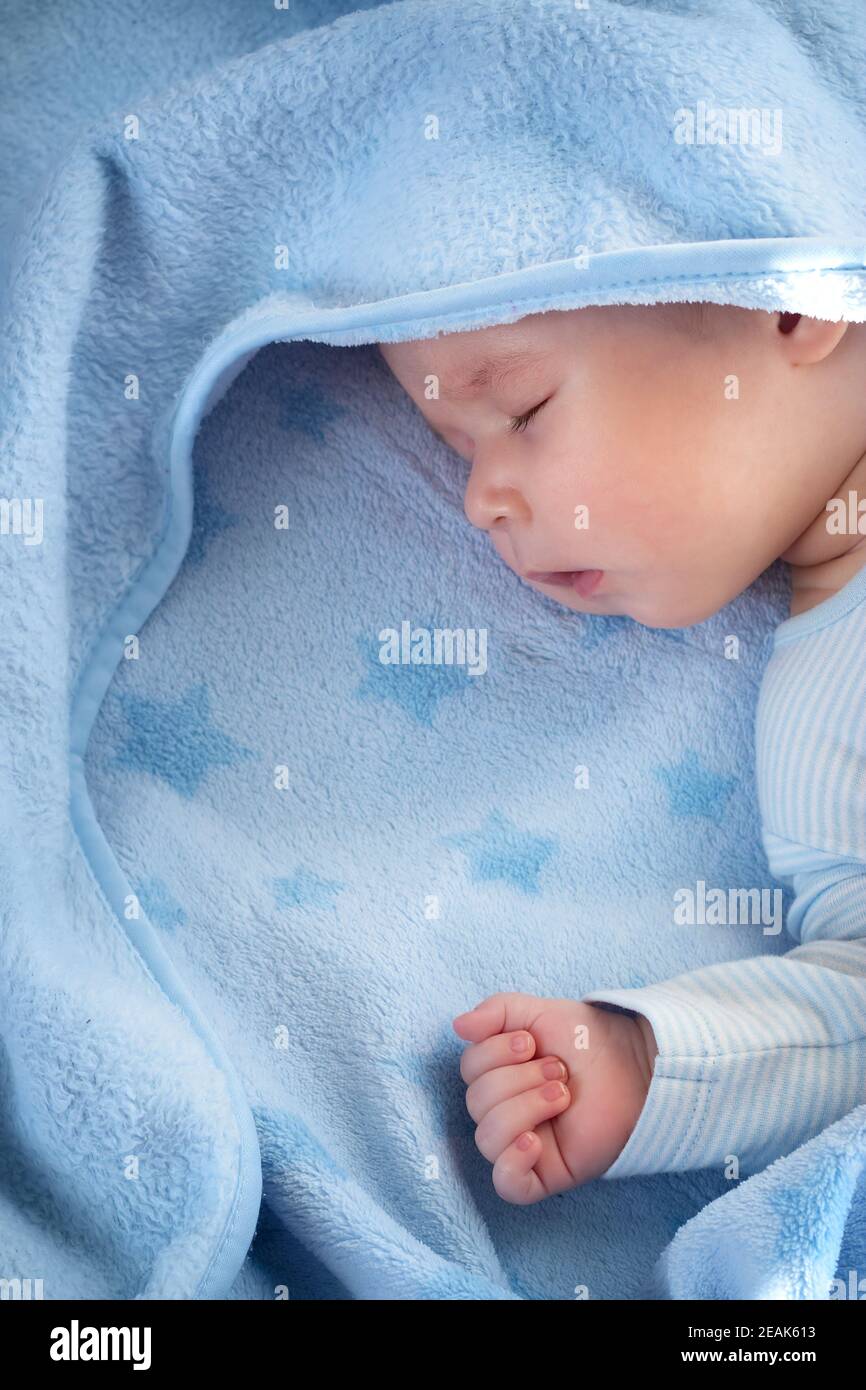 three month old baby sleeping on blue blanket Stock Photo Alamy