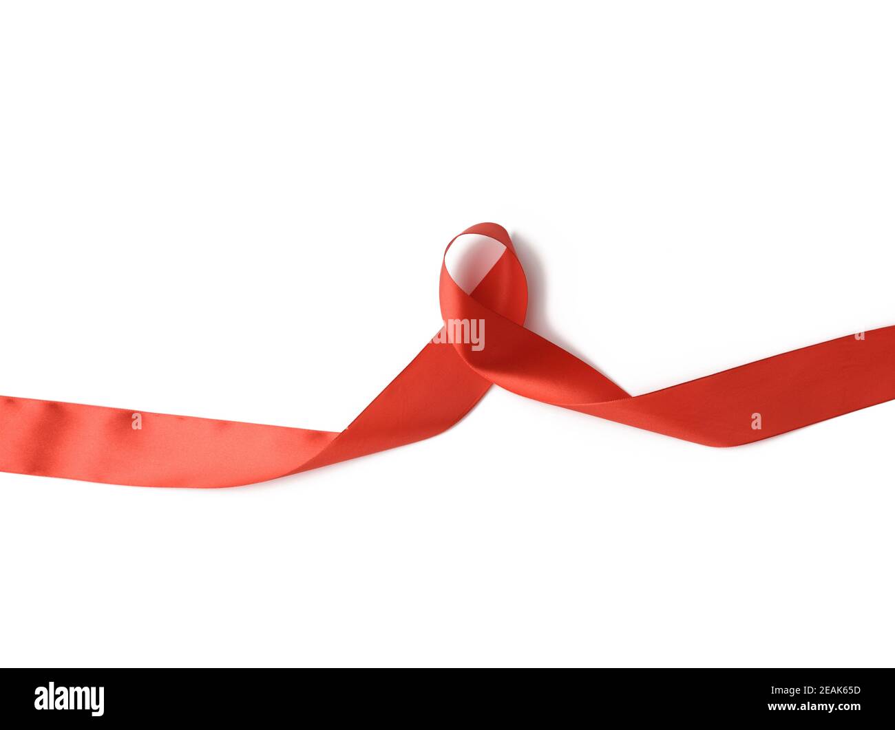 twisted red silk ribbon, yellow background - a Royalty Free Stock Photo  from Photocase