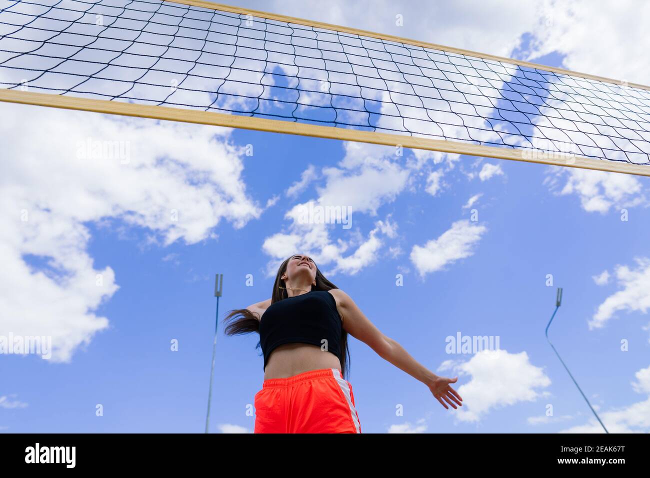 Confident teen athlete in a sportswear standing on track at stadium ...