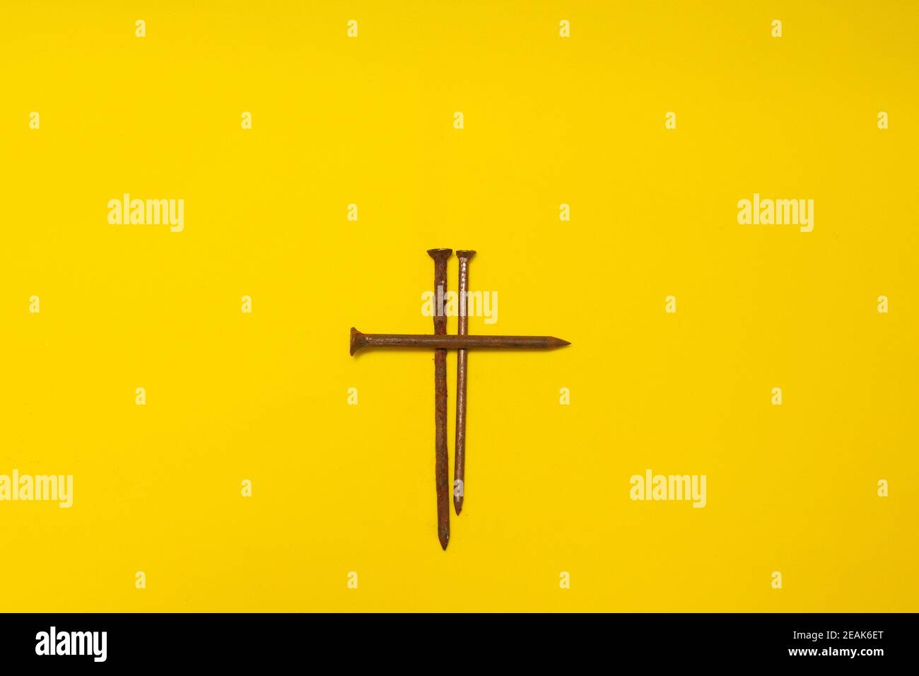metal rusty nails on a yellow background Stock Photo