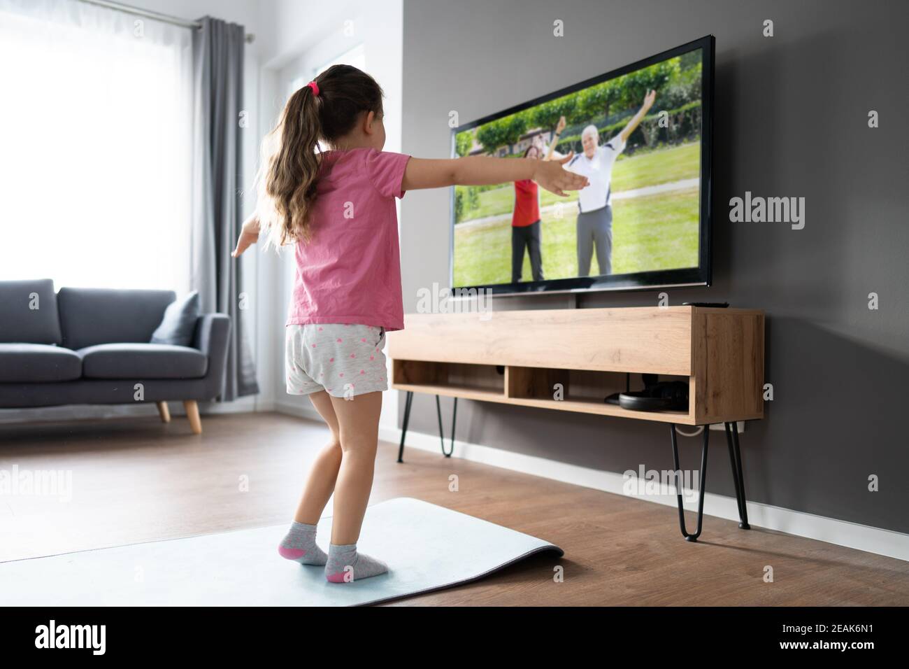 Kid Doing Online TV Fitness Exercise Stock Photo Alamy