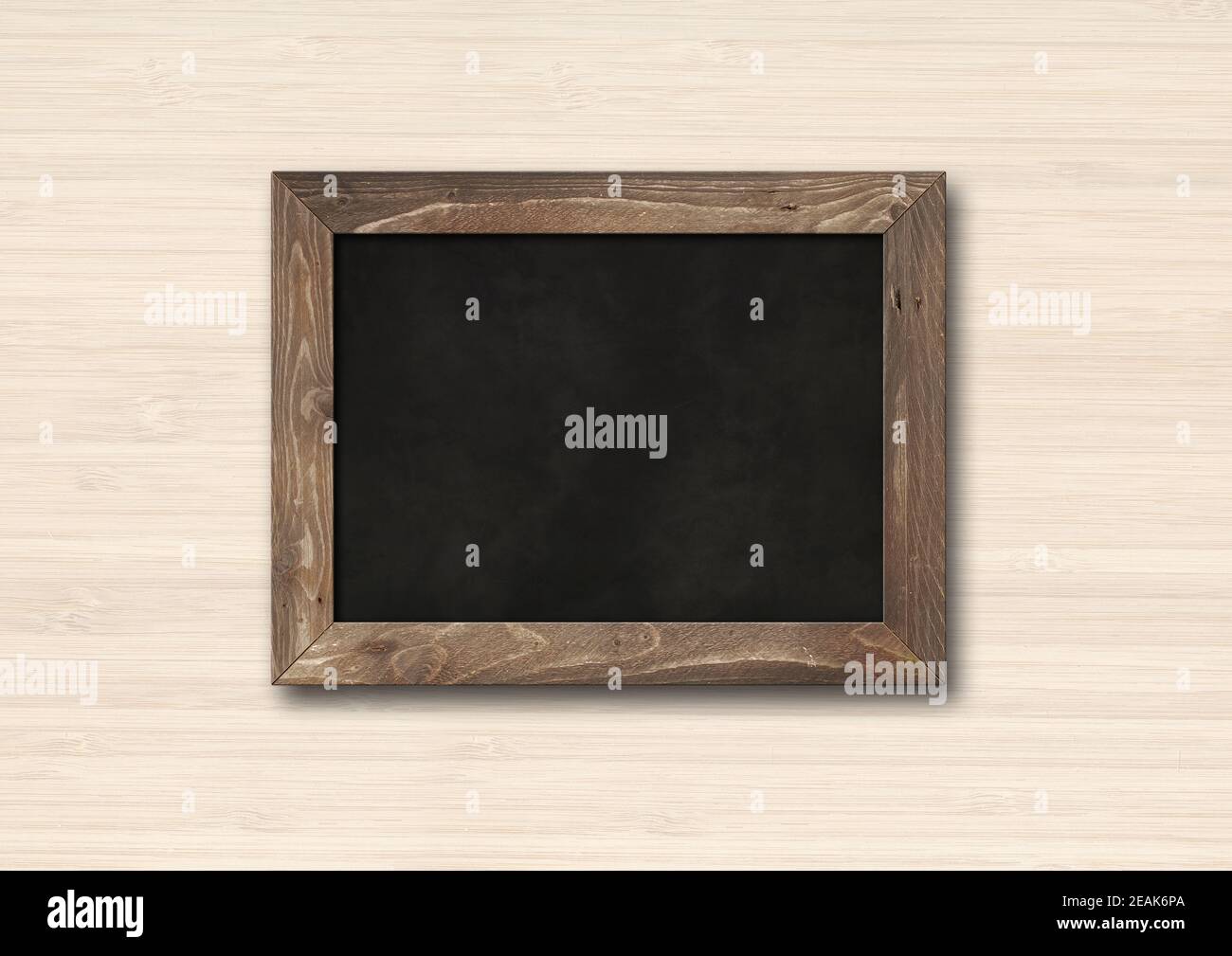 Old rustic black board isolated on a wooden background Stock Photo