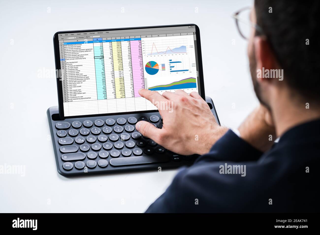 Analyst Using Spreadsheet Report On Tablet Stock Photo - Alamy