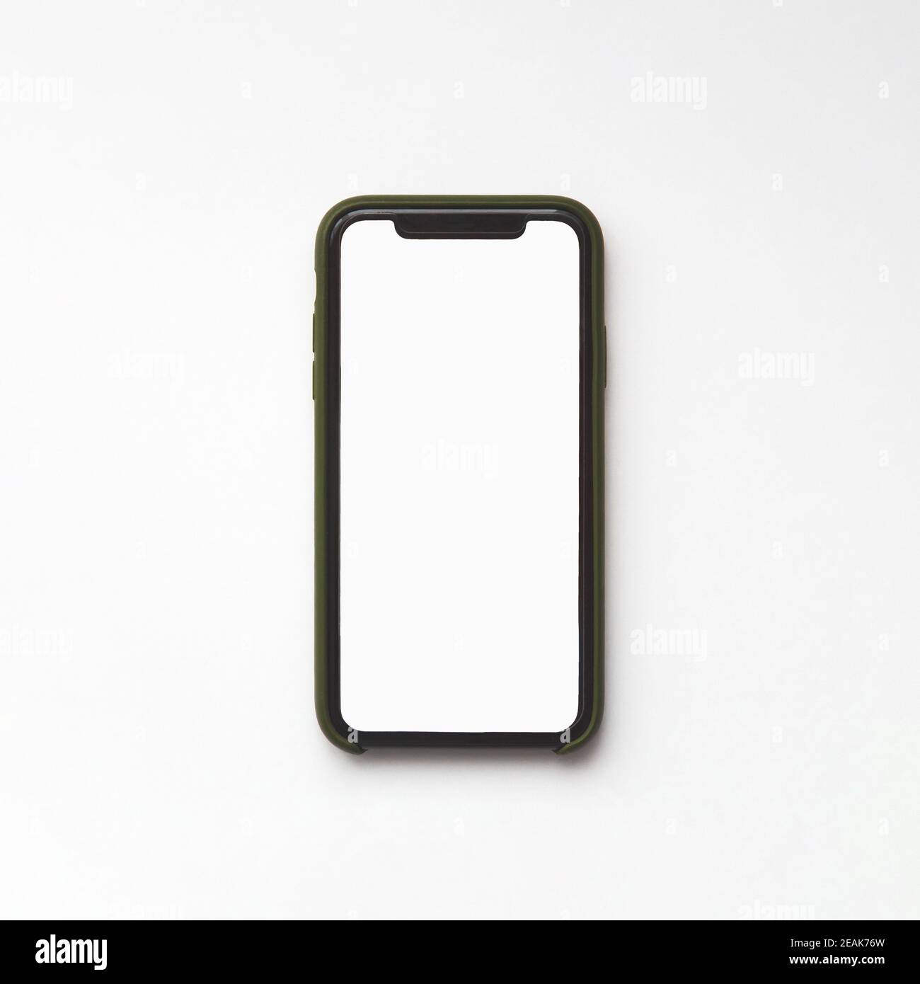 Minsk, Belarus - November 02, 2020: iPhone 11 with blank white screen in green protective case on white background, top view Stock Photo