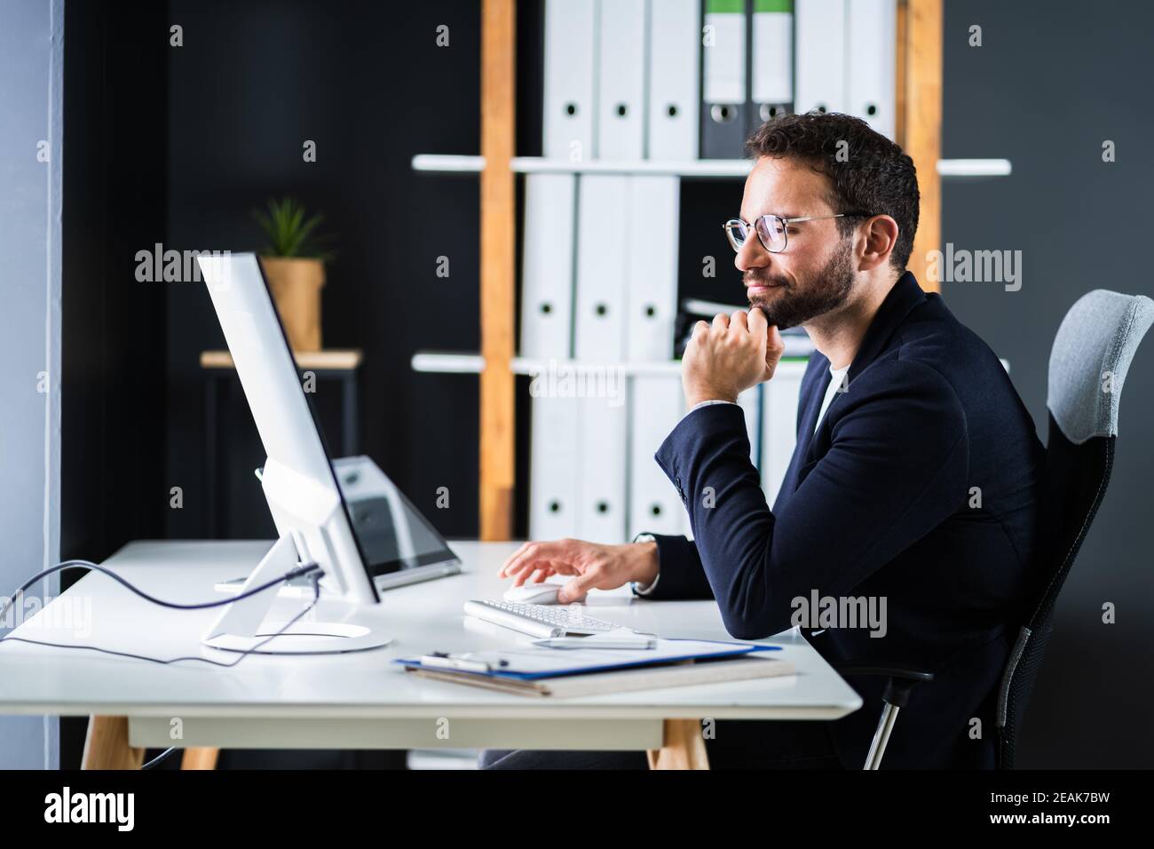 Employee Using Business Computer Stock Photo