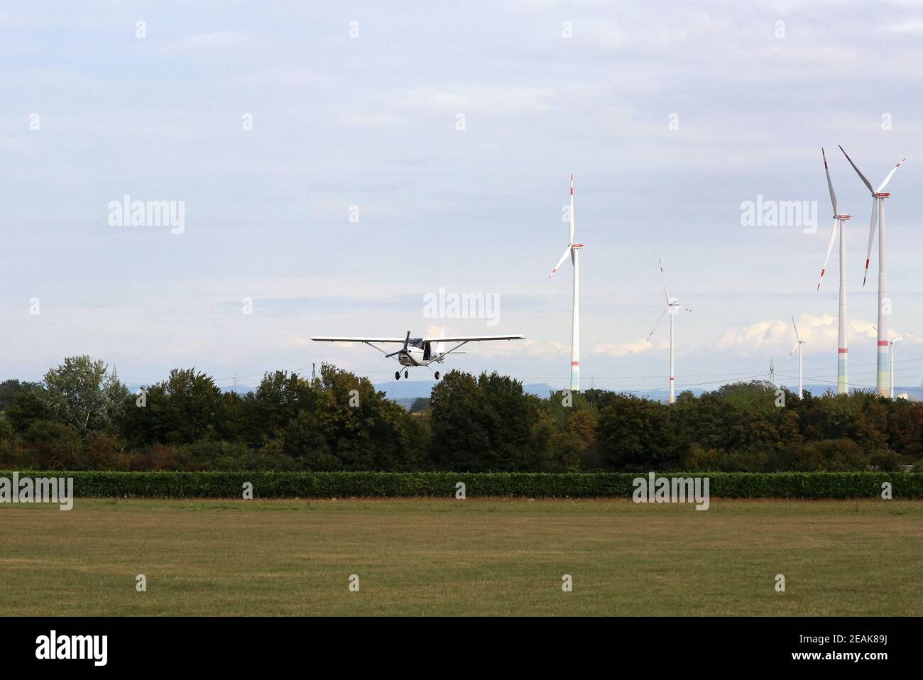 small aircraft and wind farm Stock Photo