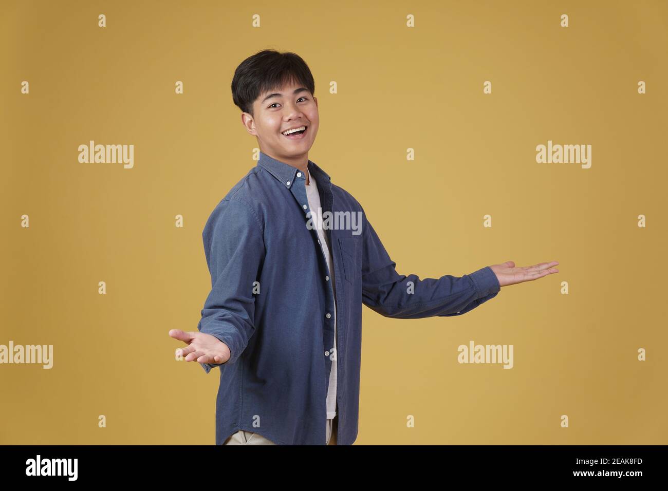 portrait of excited happy handsome young asian man dressed casually ...