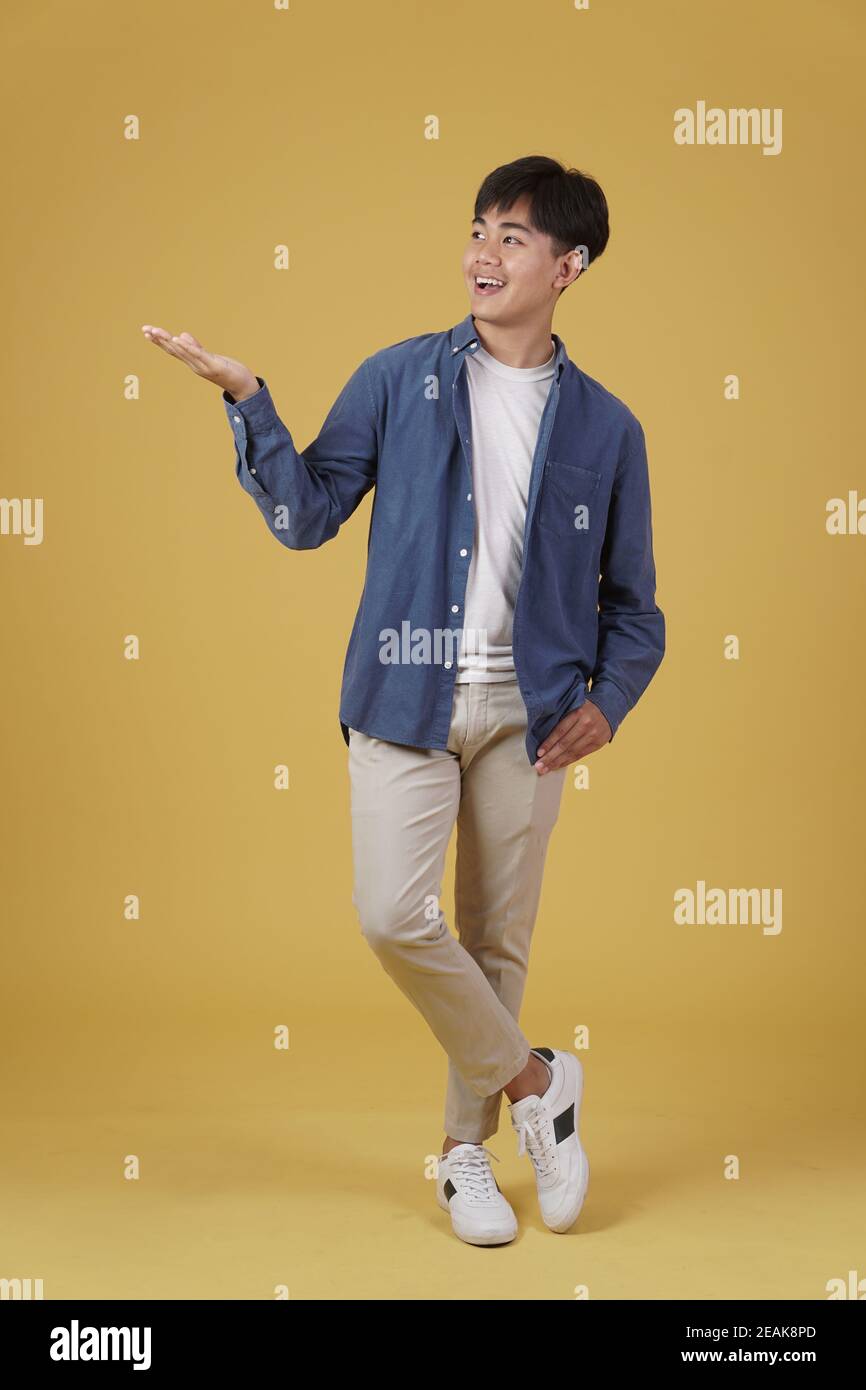portrait of excited happy handsome young asian man dressed casually ...