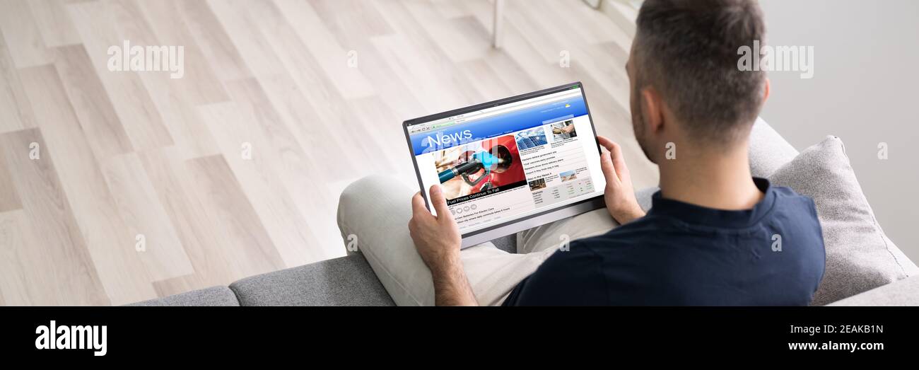 Man Using Tablet Reading Electronic News Stock Photo