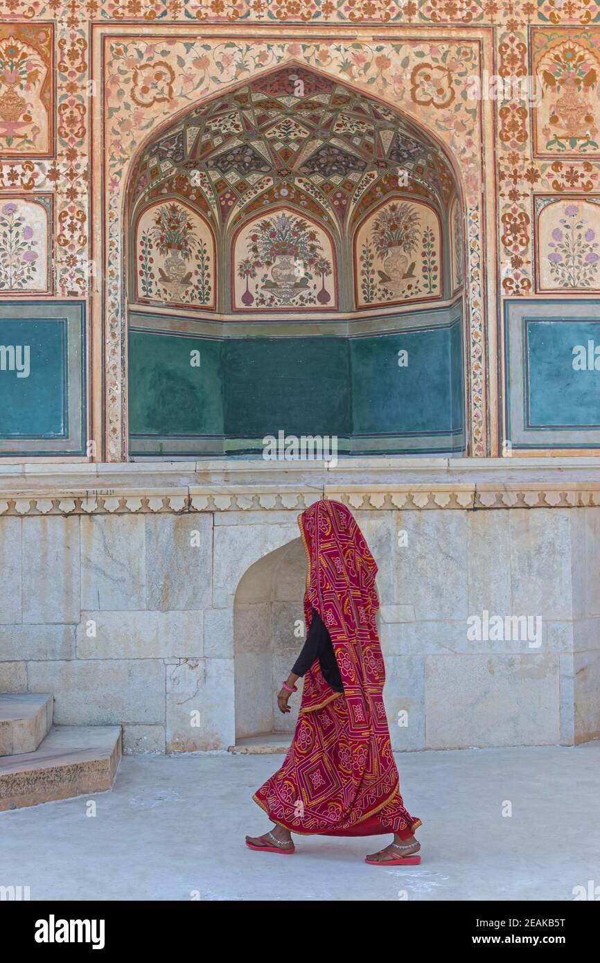 Women passing from the Sheesh Mahal gate, Amber Palace, Jaipur, Rajasthan, India. Stock Photo