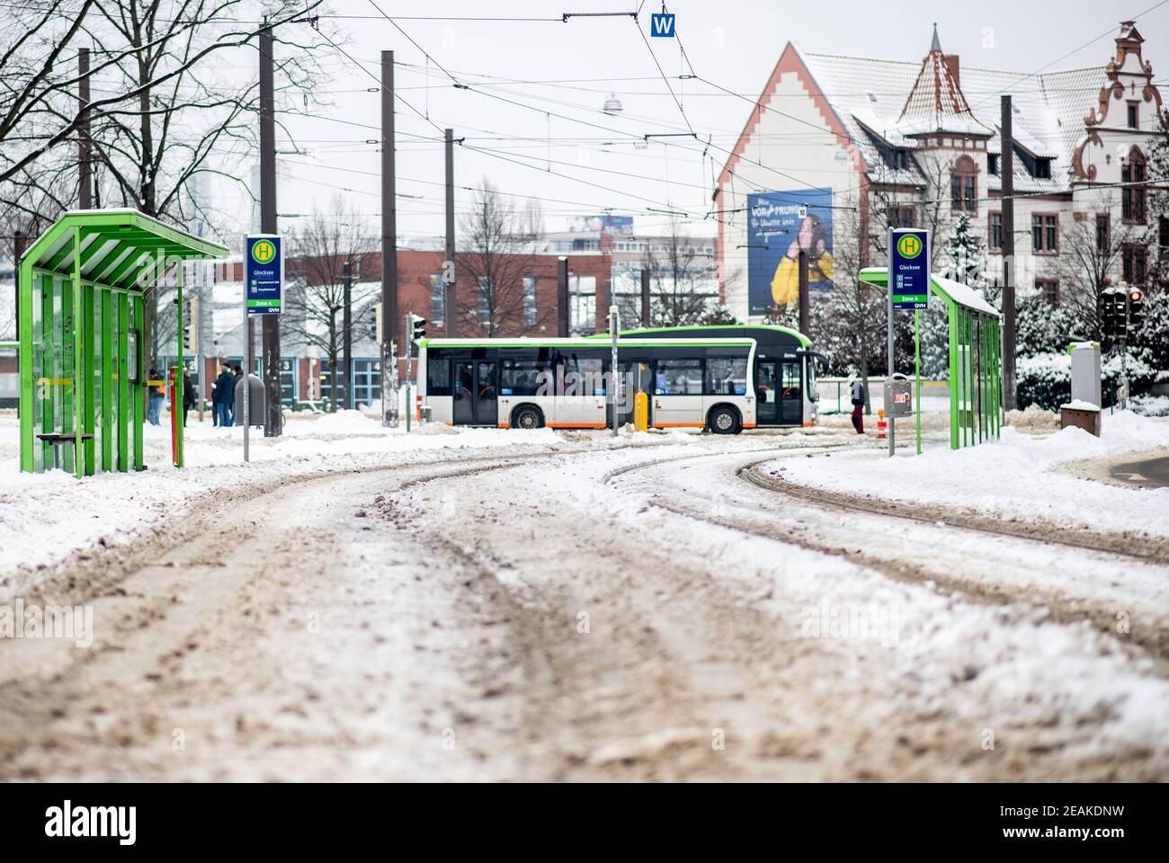 Hanover, Germany. 10th Feb, 2021. A public bus drives past the snow-covered Glocksee stop of the city railway in Calenberger Neustadt. Due to frost damage, the ÜSTRA Hannoversche Verkehrsbetriebe has suspended rail services throughout the city. Credit: Hauke-Christian Dittrich/dpa/Alamy Live News Stock Photo