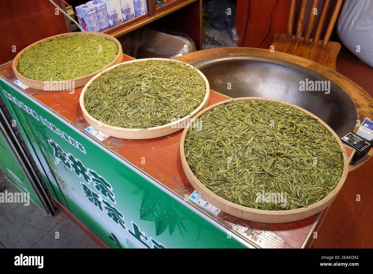 Various types of tea in wooden bowls exposed for sale in a Chinese tea