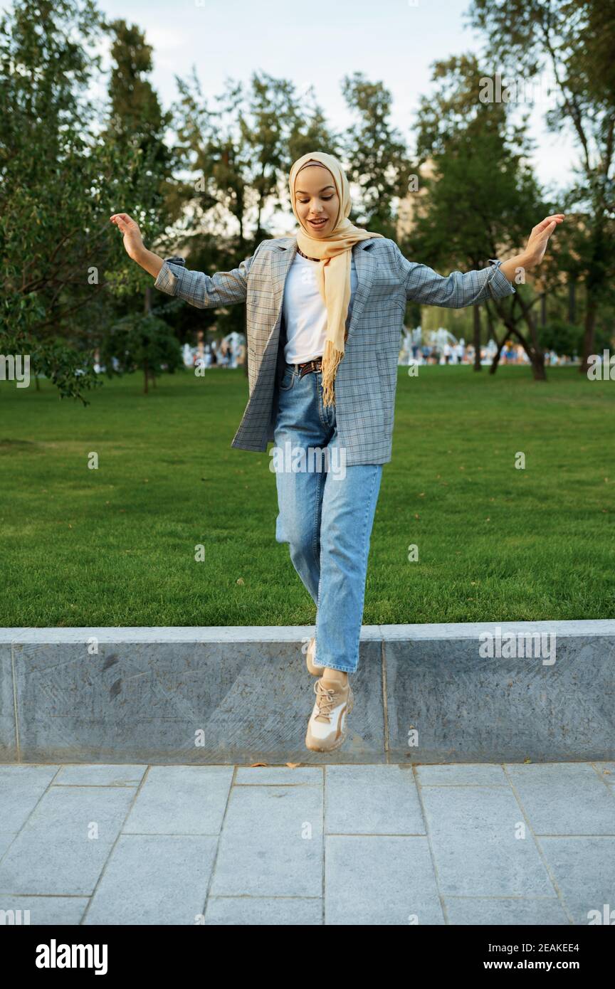 Beautiful arab female student poses in summer park Stock Photo