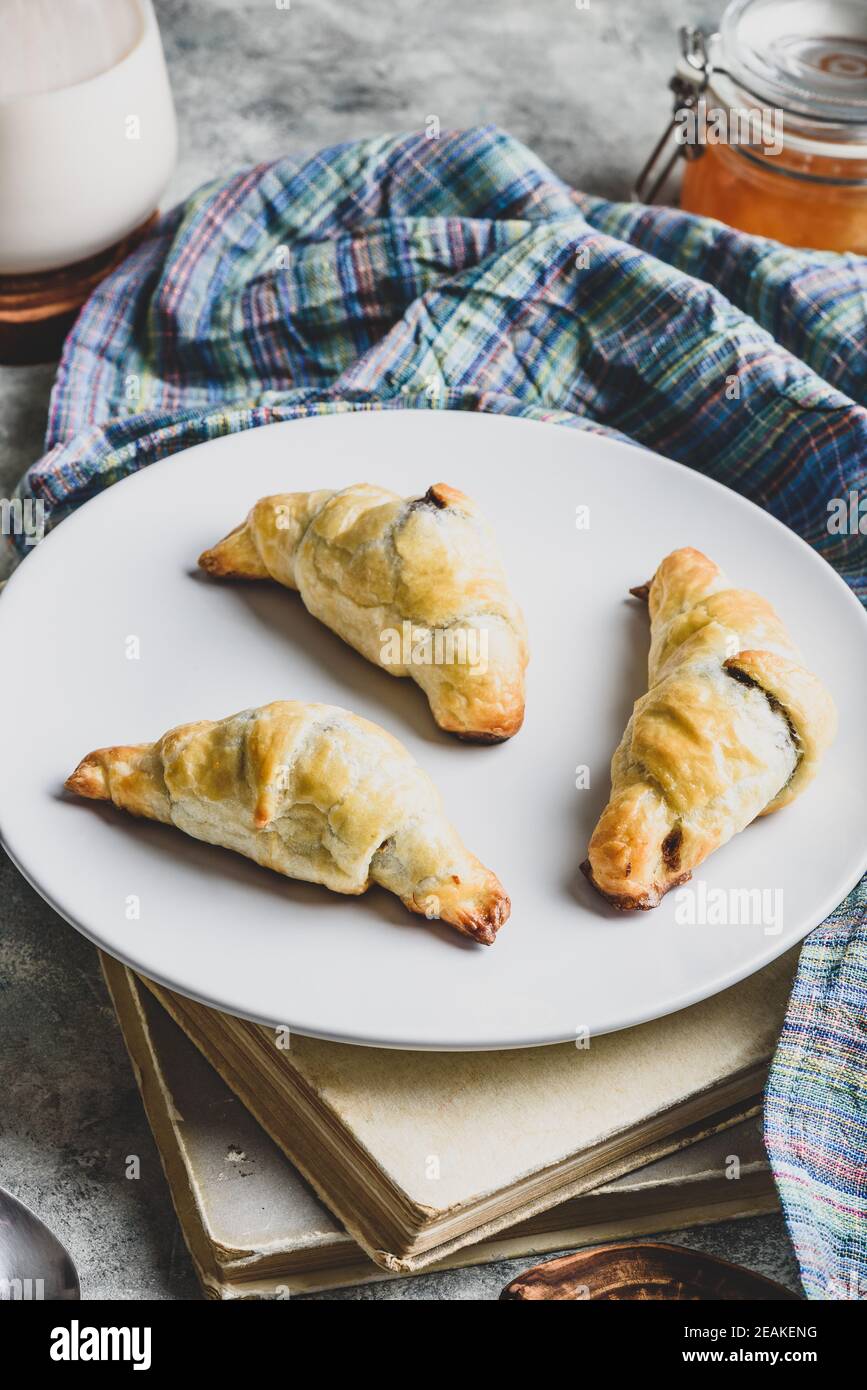 Croissants stuffed with nuts and chocolate for breakfast Stock Photo