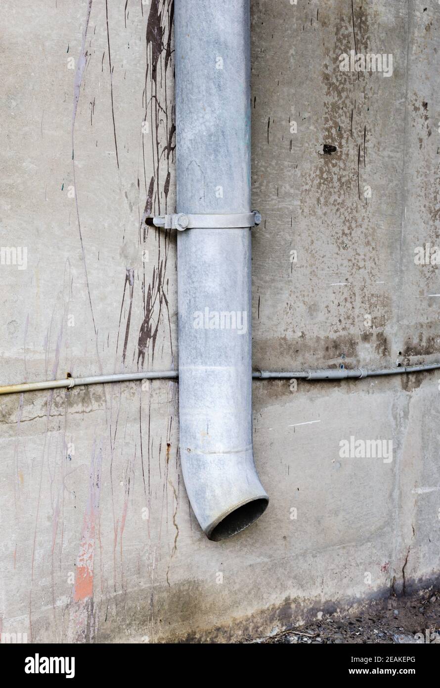 Vertical drain pipe on dirty concrete wall Stock Photo Alamy