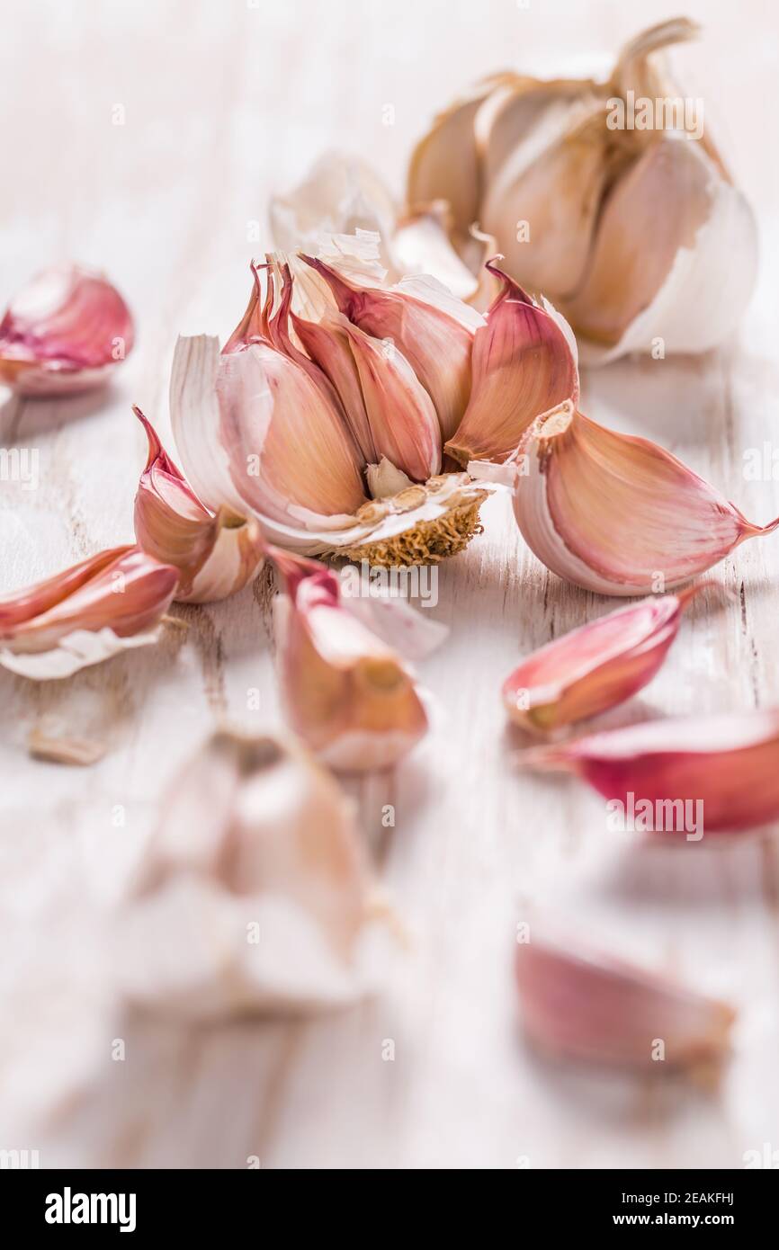 Garlic bulb and garlic cloves on white wooden background Stock Photo ...