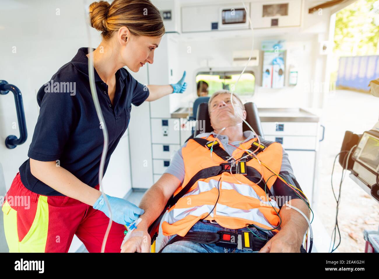 Paramedic in ambulance car giving driver the sign to drive off Stock Photo