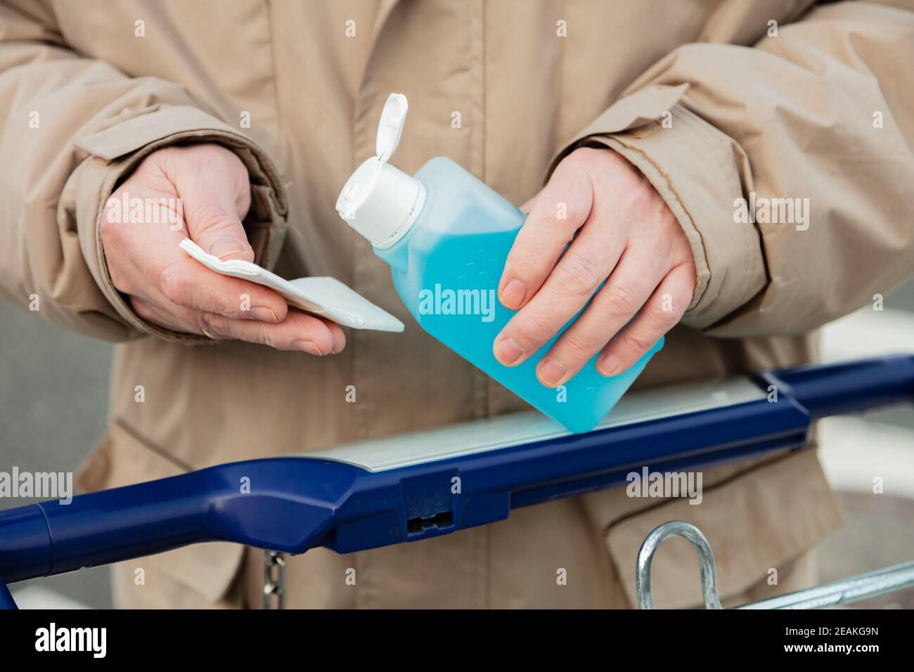 Mans Hand hold a plastic bottle with disinfectants Stock Photo