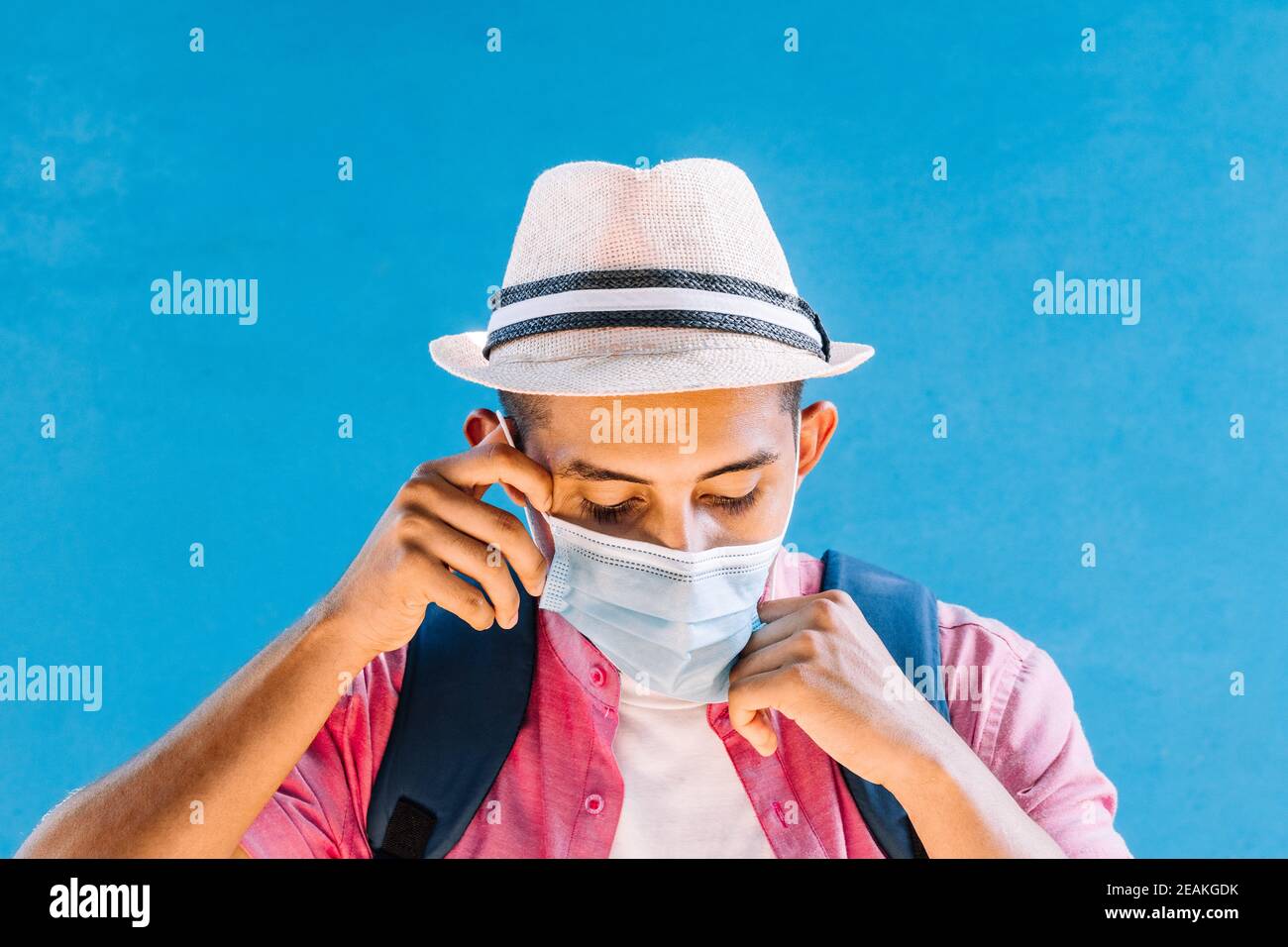 young man taking off his mask Stock Photo Alamy