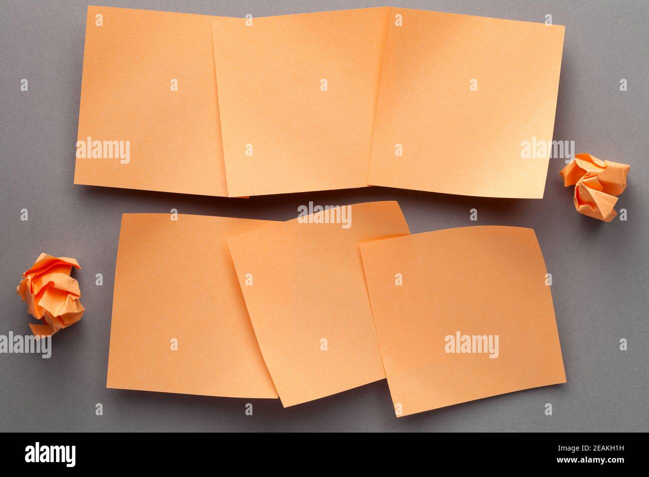 Orange Blank Paper Notes And Crumbled Paper Stock Photo