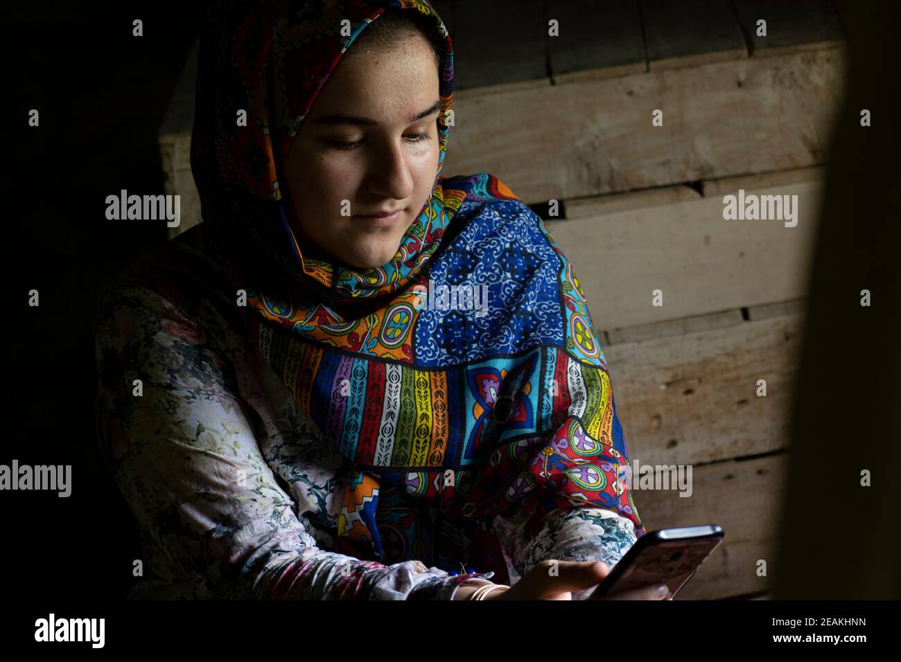 Portrait of an attractive teenage Muslim girl working with smart phone Stock Photo