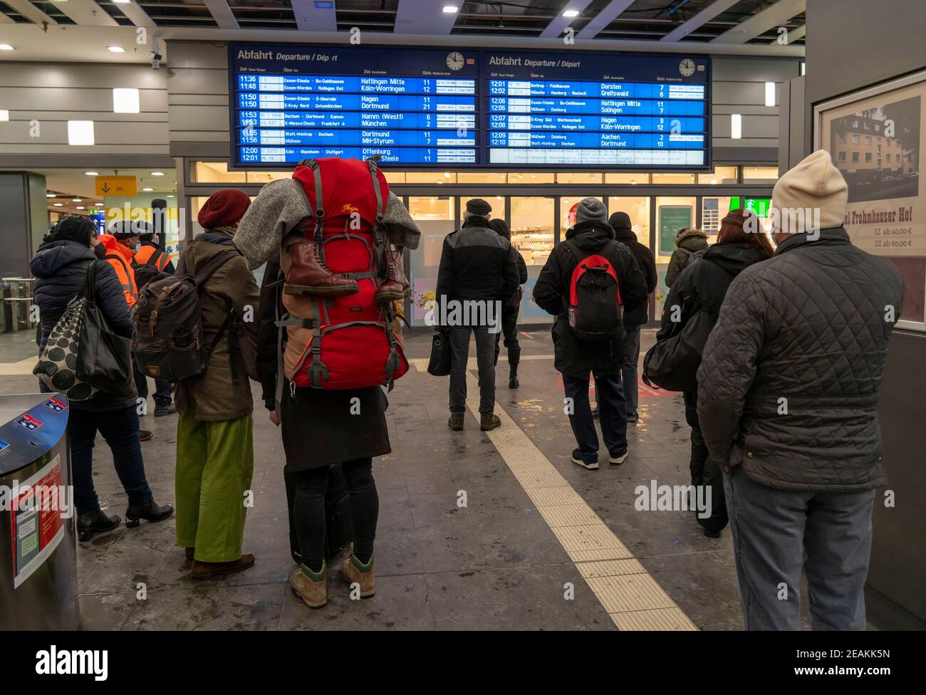 Essen central station, travellers inform about cancelled train connections, partly full closure of the railway traffic, due to a winter onset with a l Stock Photo