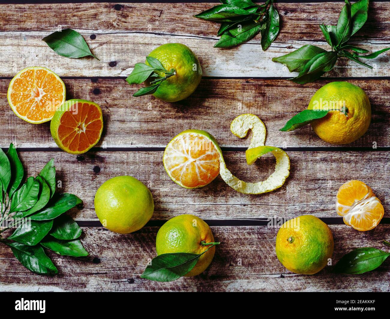 Green mandarins on wooden background, top view Stock Photo