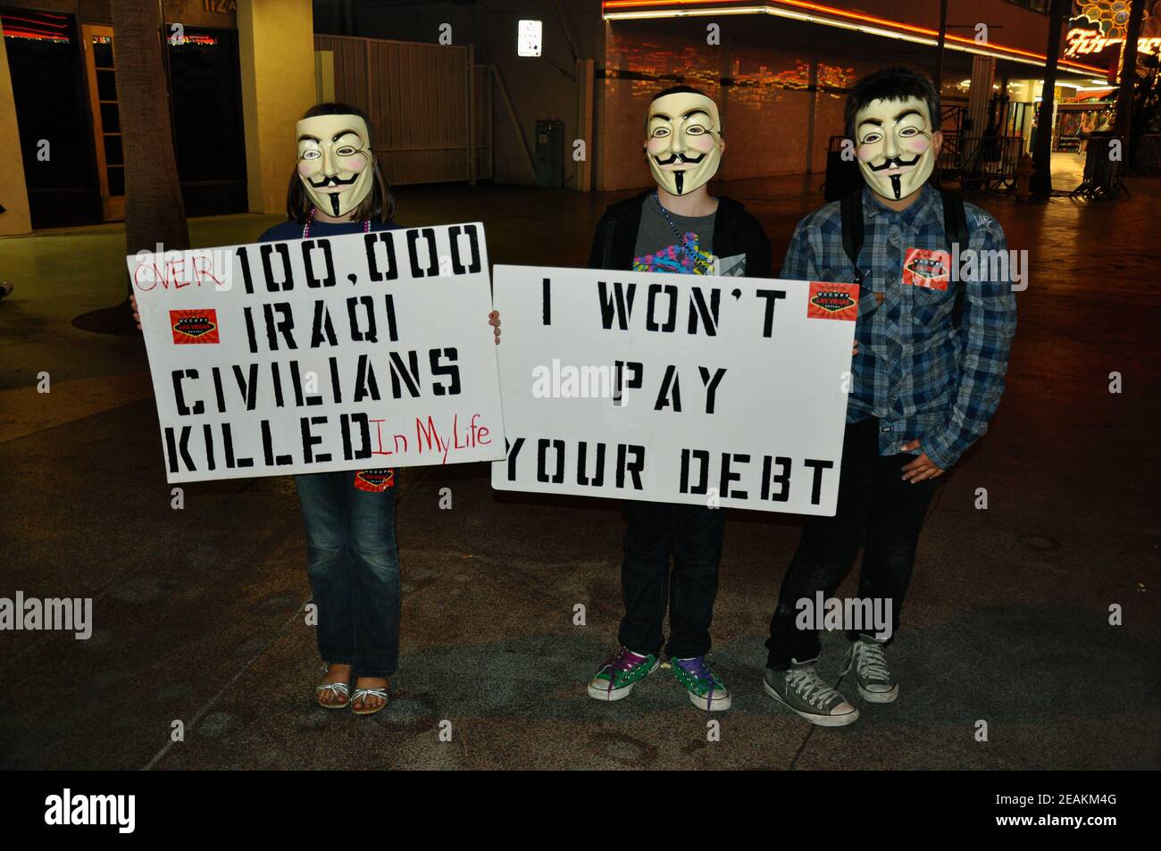 Protesters in the Occupy Las Vegas movement pose while holding signs with a message. Stock Photo