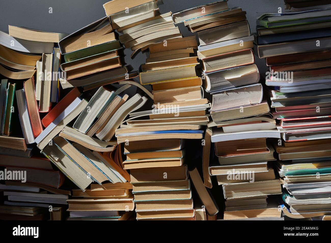 Wall of books piled up Stock Photo