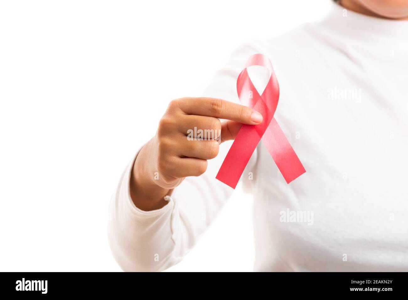 Woman holding HIV AIDS awareness red ribbon Stock Photo