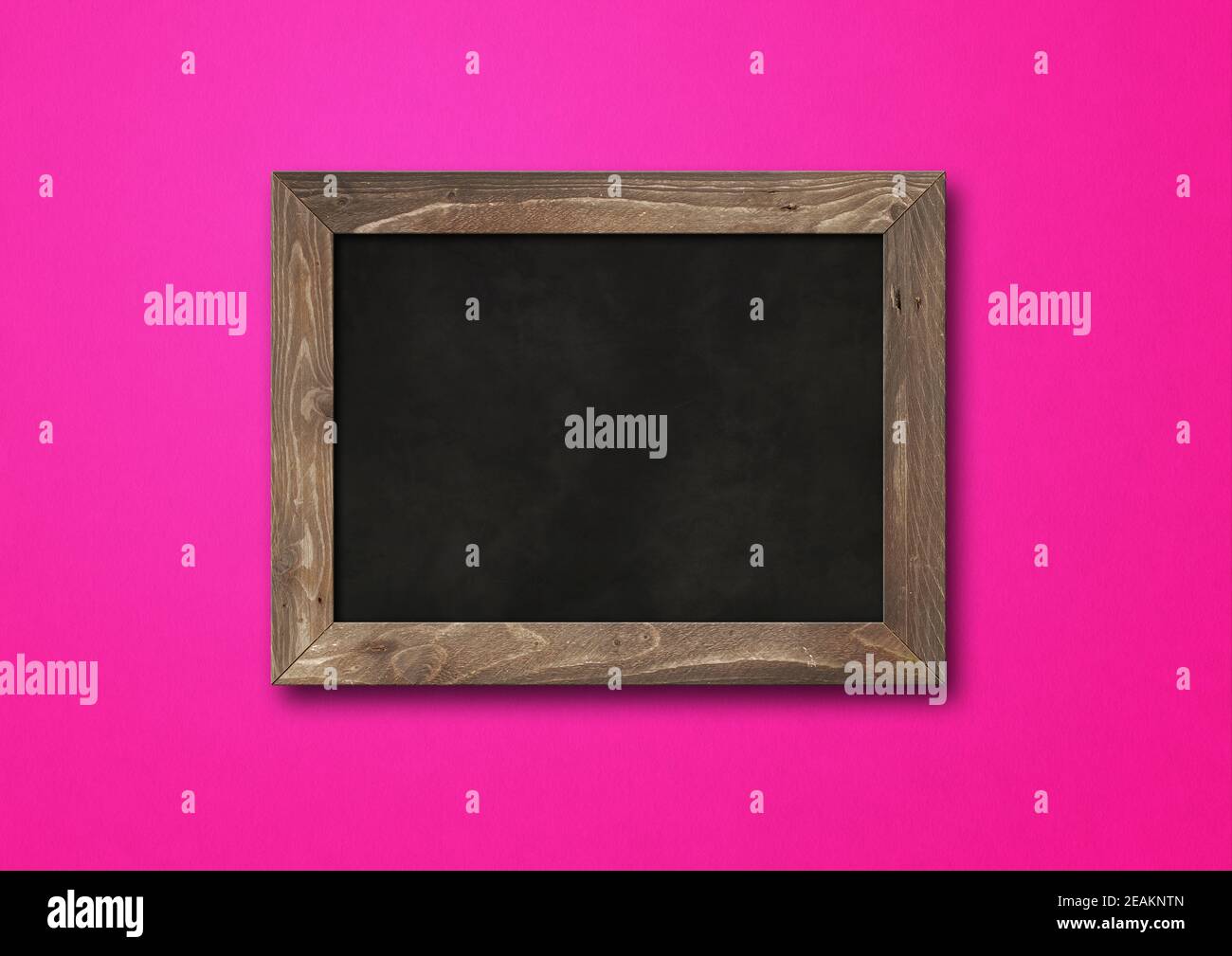 Old rustic black board isolated on a pink background Stock Photo
