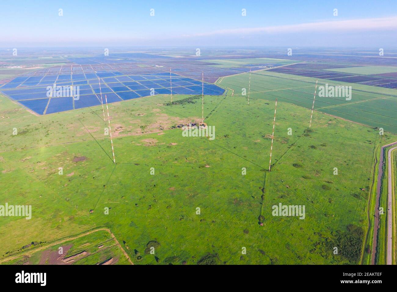 Masts longwave antennas communication among the rice fields floo Stock Photo