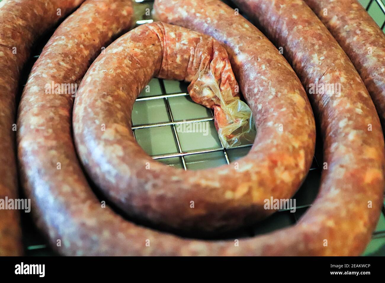 Closeup of raw coiled ham and garlic sausage Stock Photo