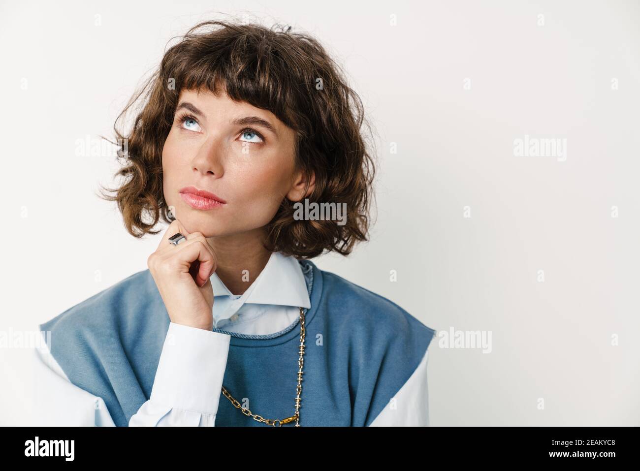 Caucasian beautiful girl posing and looking upward isolated over white ...