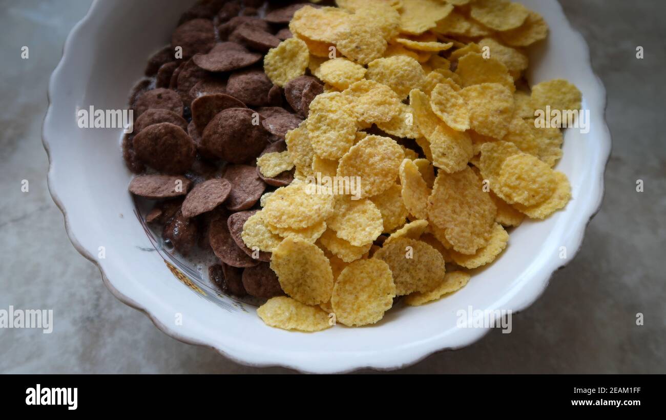 Bowl of black and yellow cereals on grey background side view Stock Photo -  Alamy