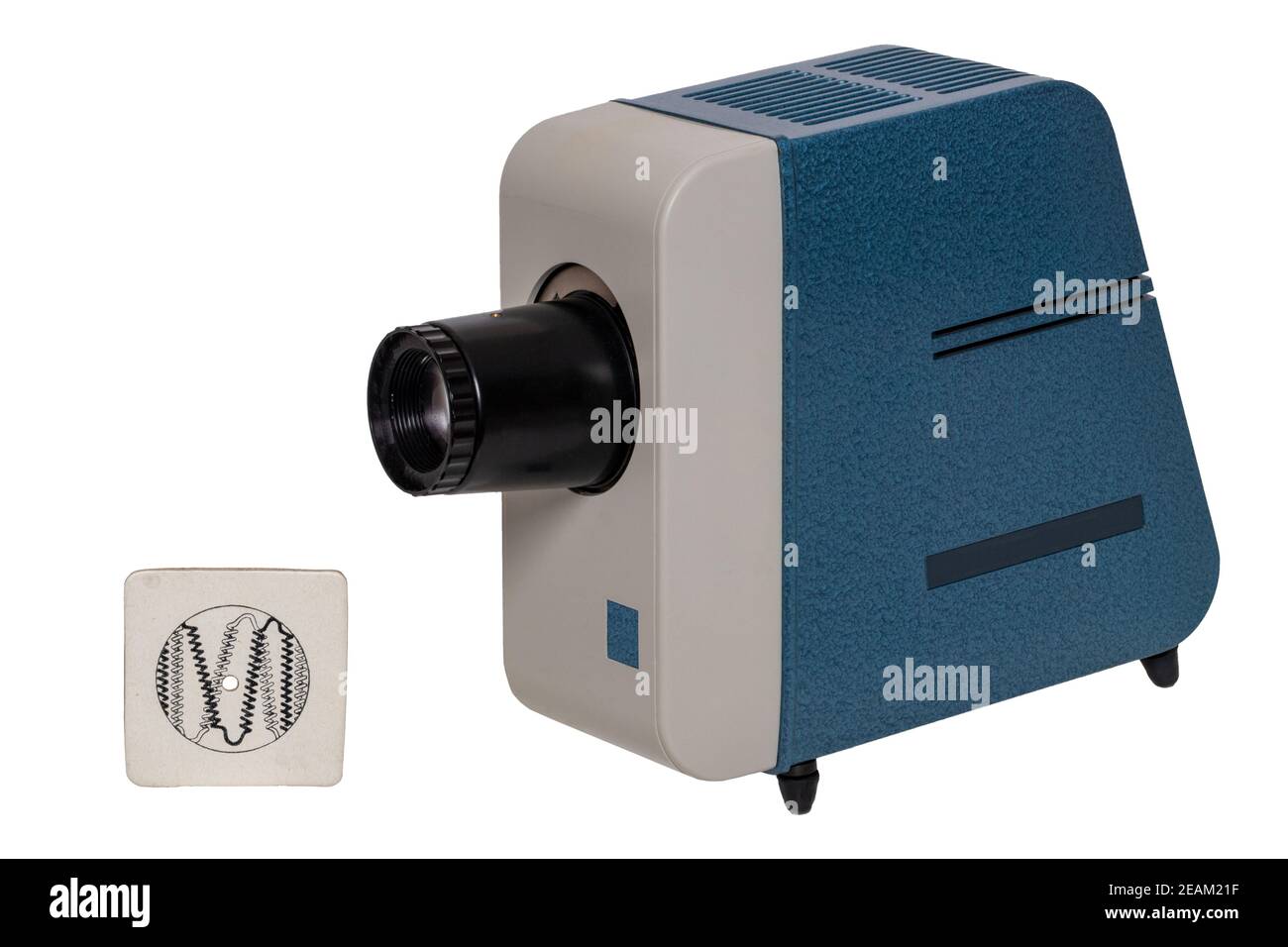 Vintage projector. Close-up of a old blue gray projector for viewing slides and filmstripes isolated on a white background. The projection lamp was adjusted with the aid of the pinhole diaphragm, which was used instead of a slide. Stock Photo