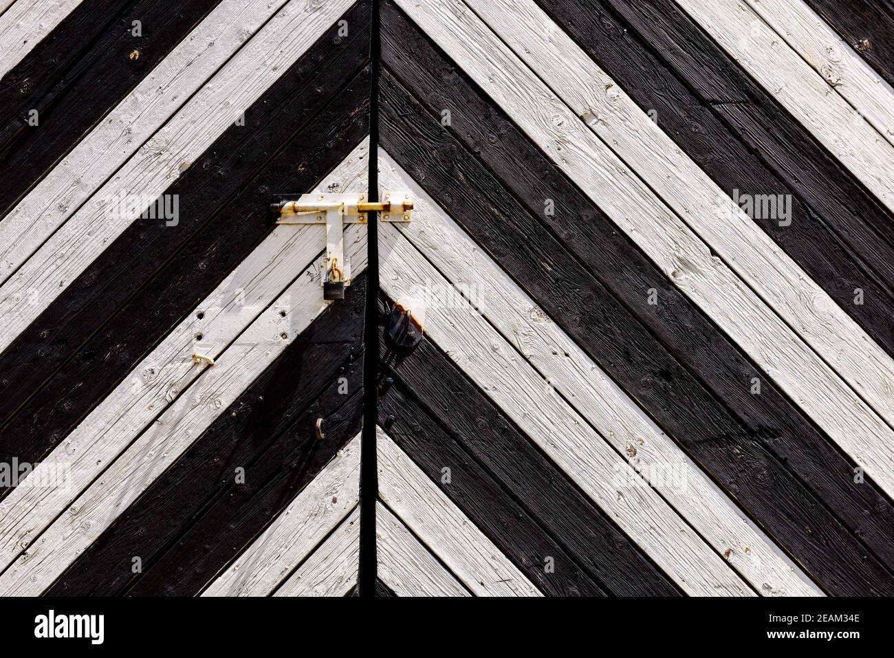 Wooden background. Detail of old wooden gates, doors with cracked paint. Black and white old wooden planks Stock Photo