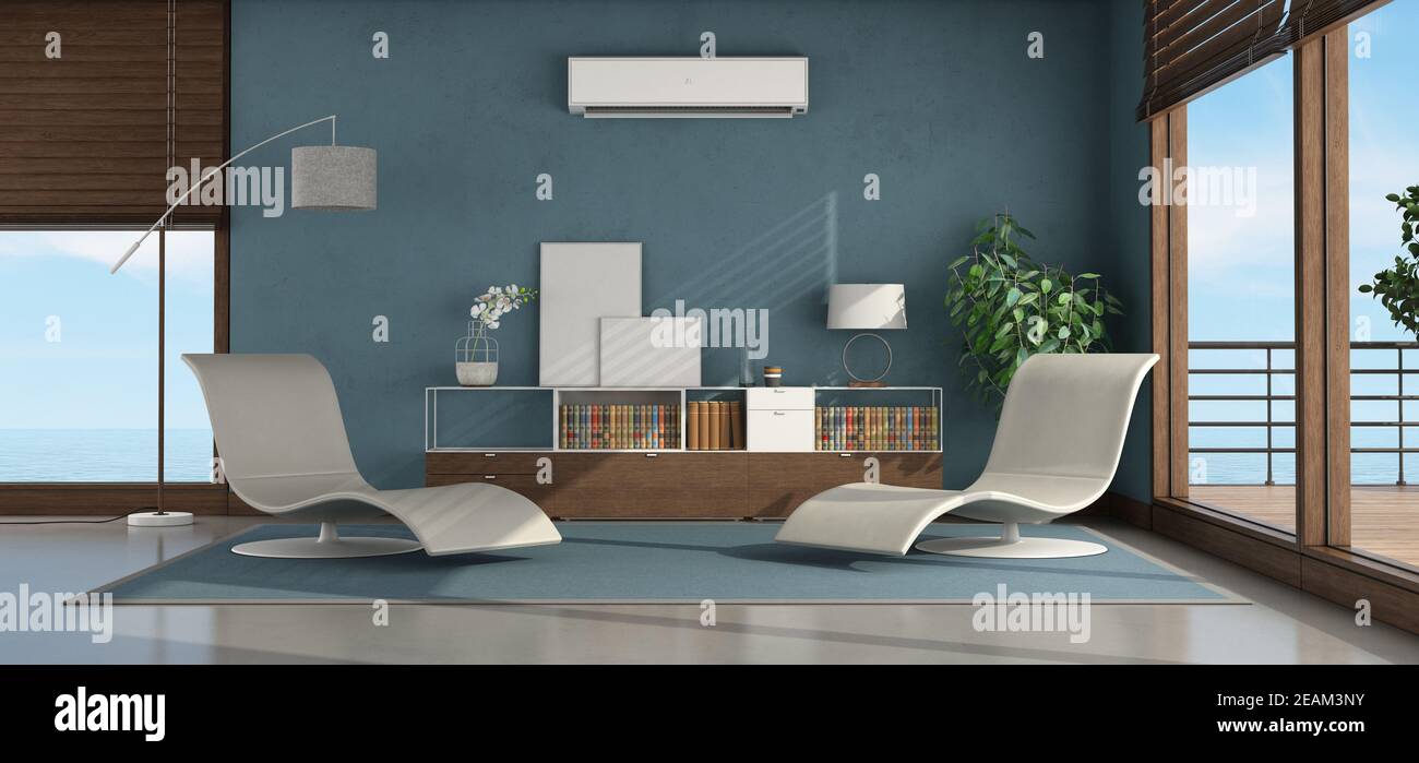 Interior of a seaside house with modern furniture and air conditioner on the blue wall Stock Photo