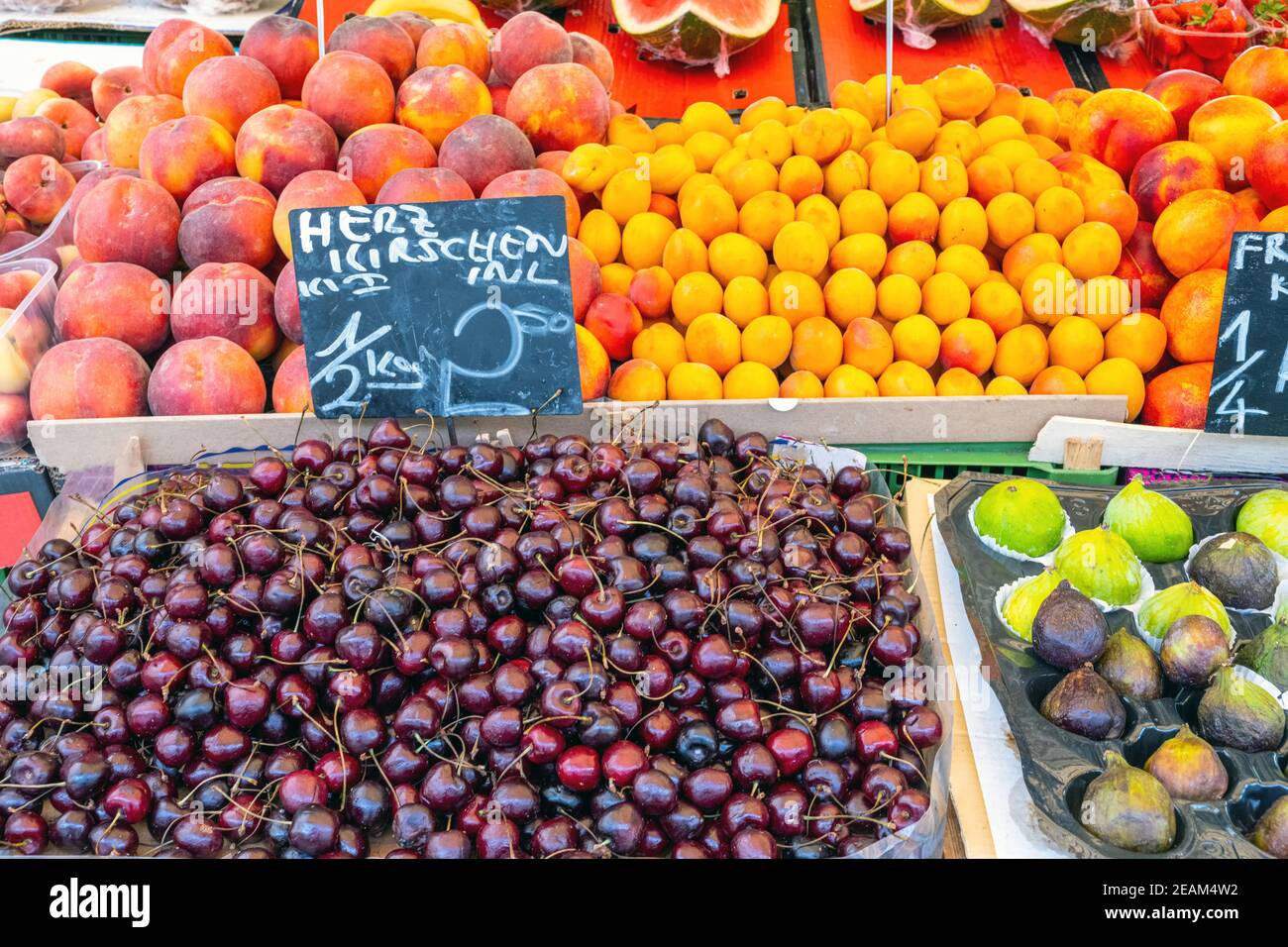 Cherries, plums and other fruits for sale a market Stock Photo Alamy