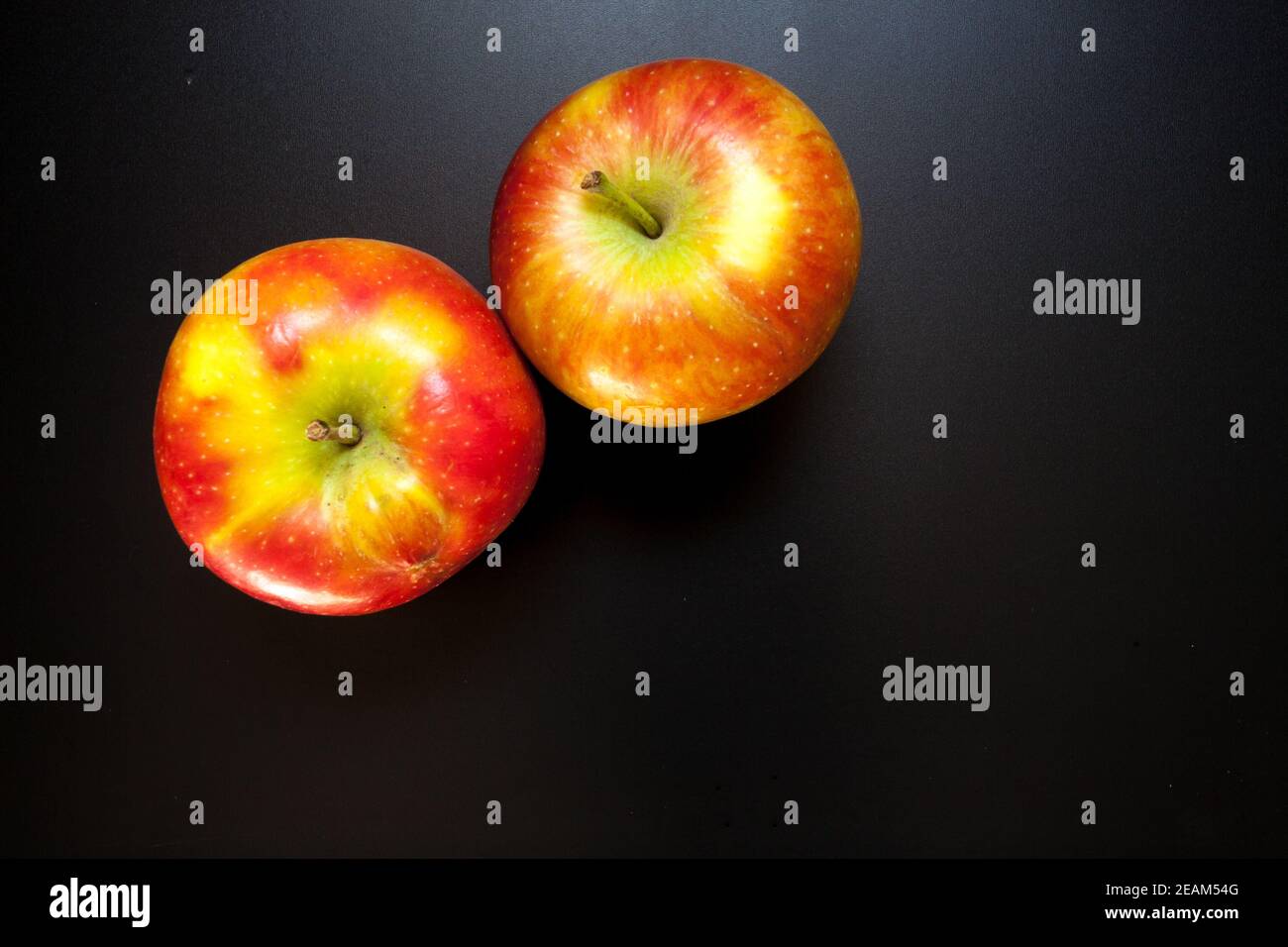 Apples on black table, food background Stock Photo