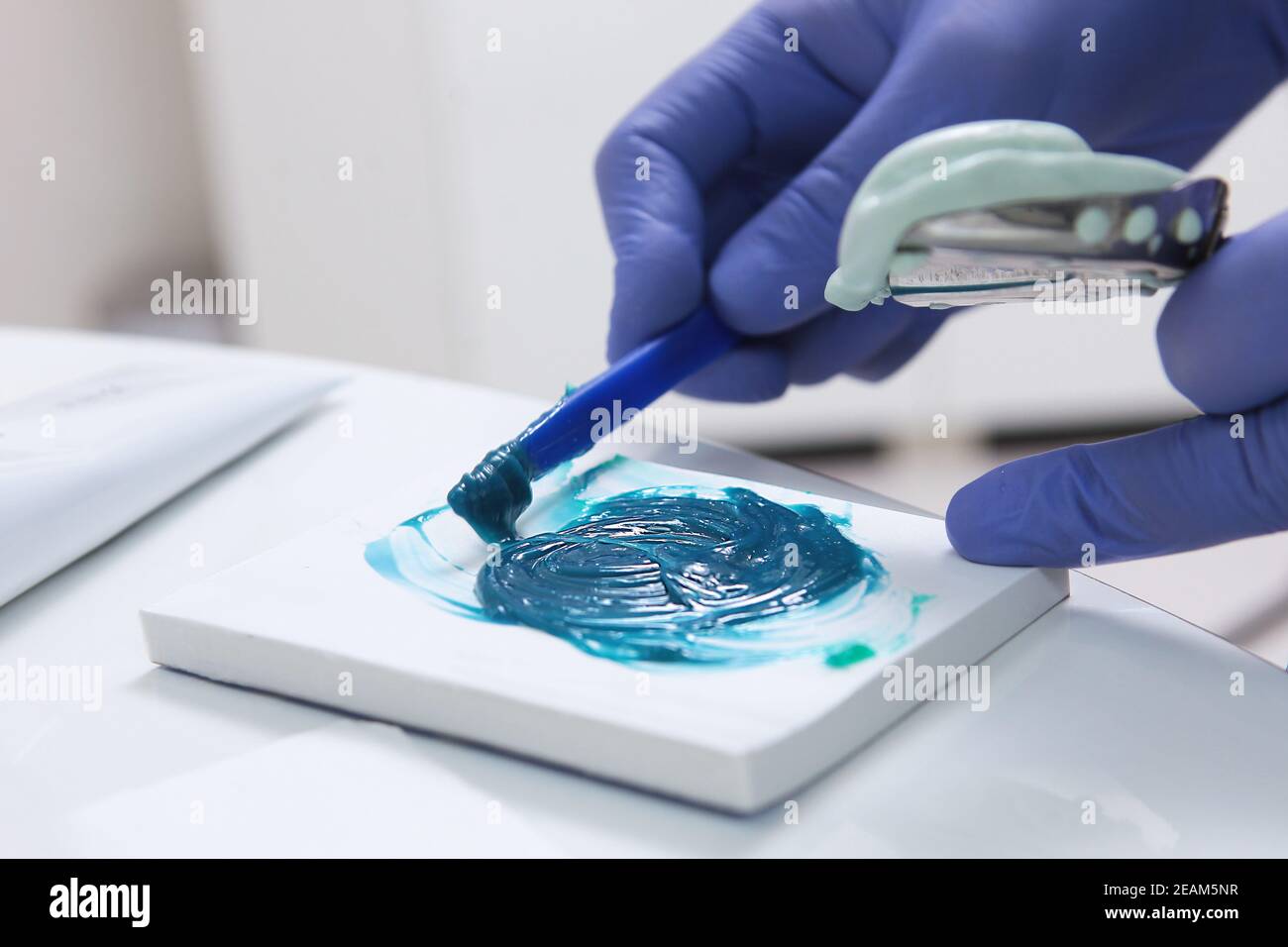 Dental material for dental impressions. Hands in protective gloves. The