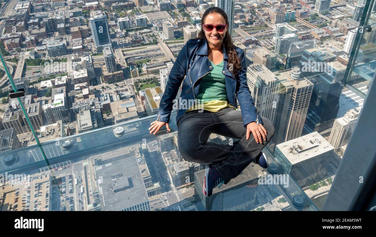 woman in glass box in Chicago Illinois Stock Photo Alamy