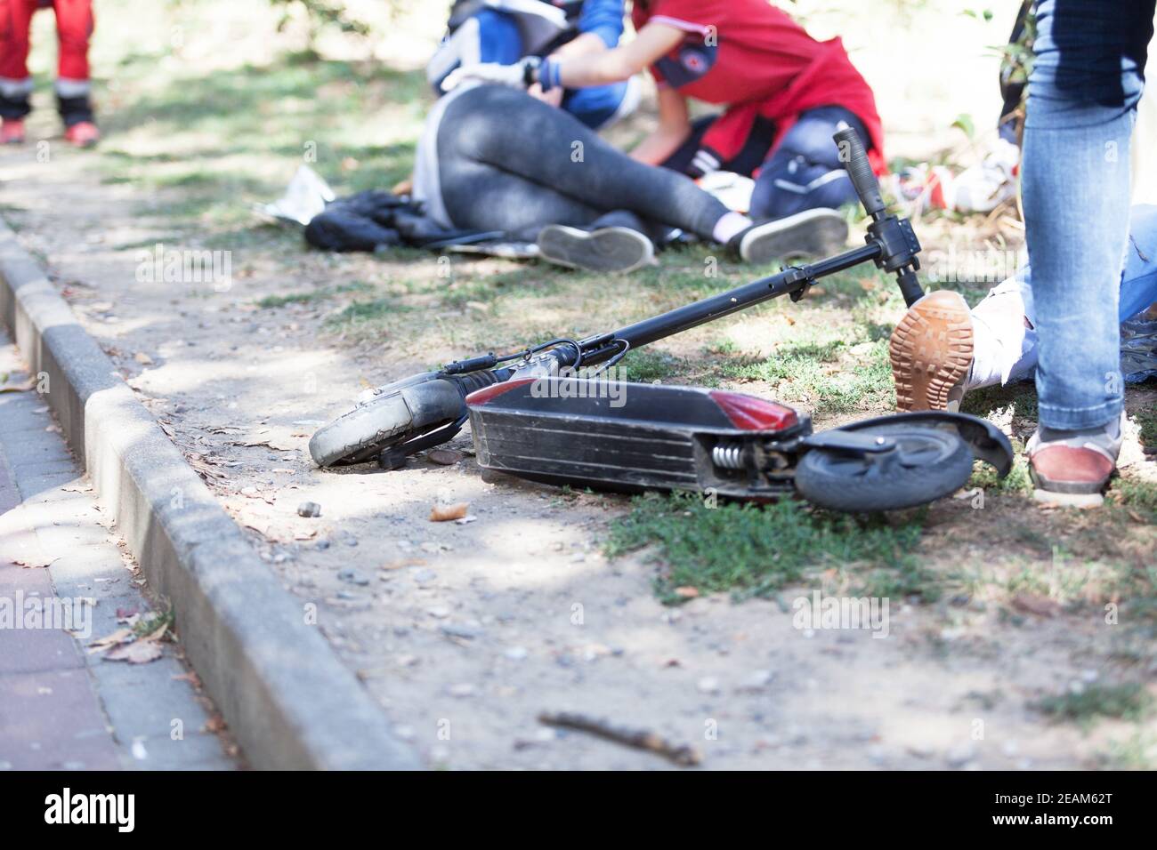 First aid for electric scooter rider injured in an accident Stock Photo