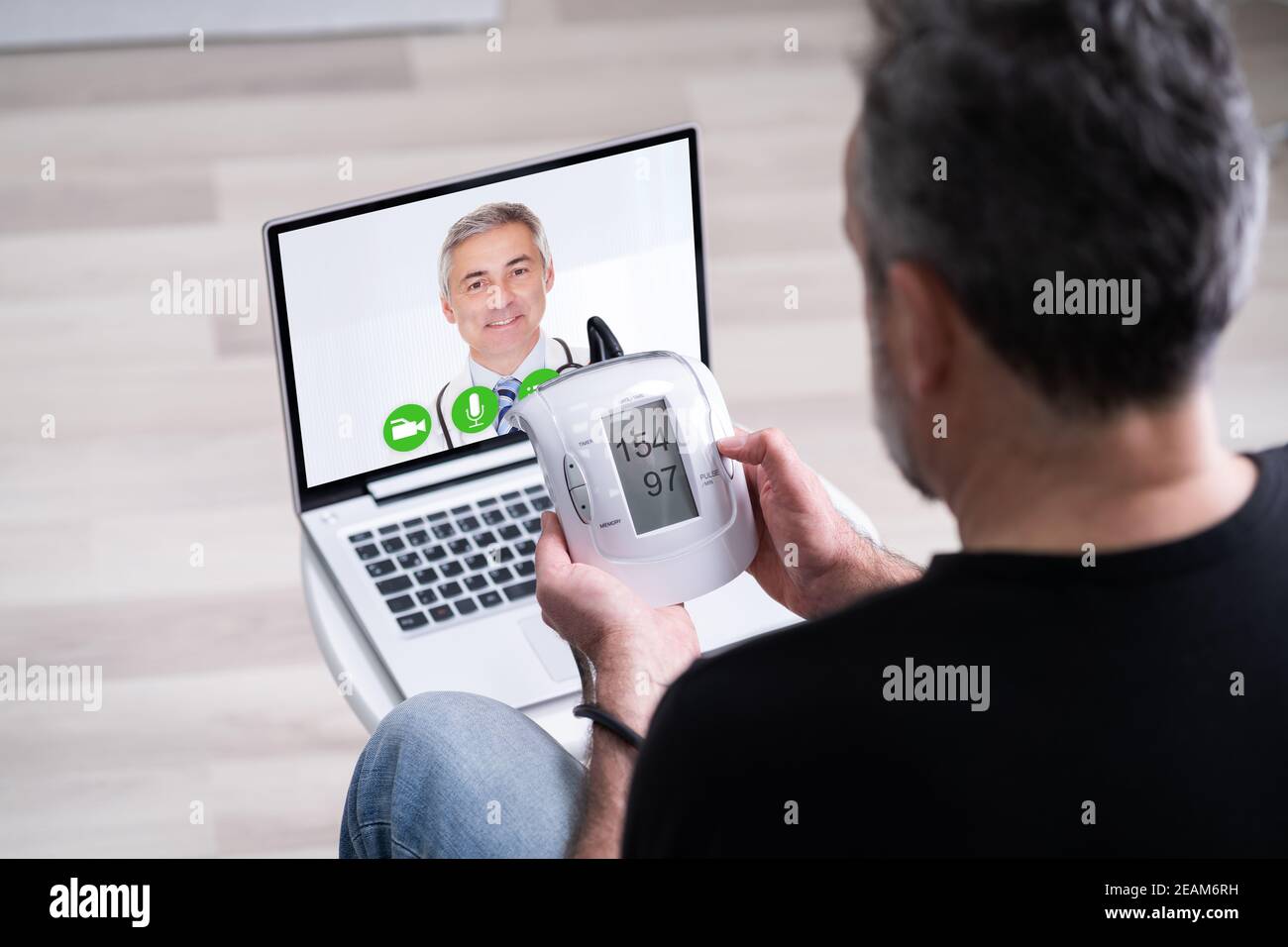Old Senior Man With Hypertension Video Conferencing Stock Photo