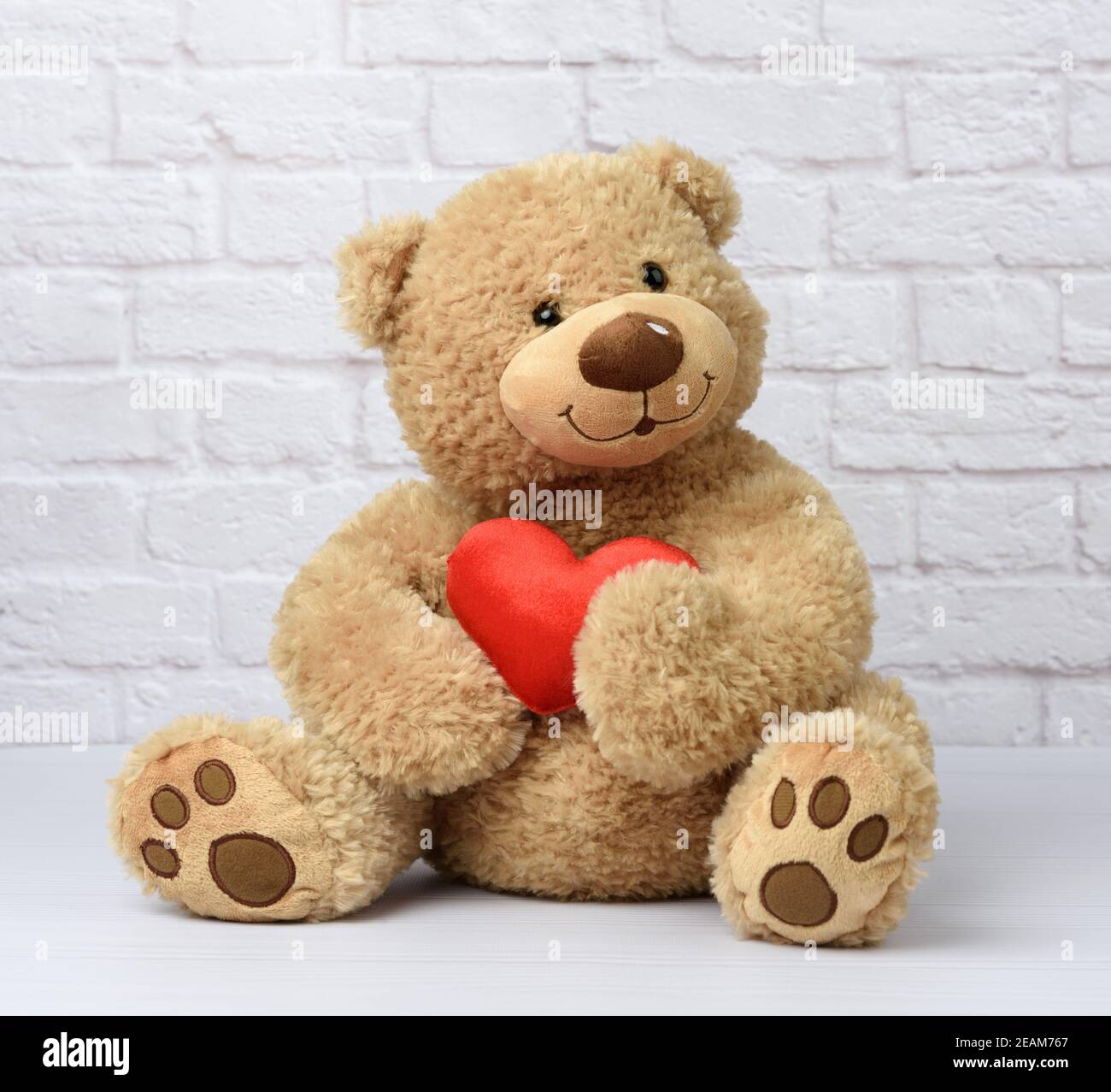 brown teddy bear sits on a white background, children's toy Stock Photo