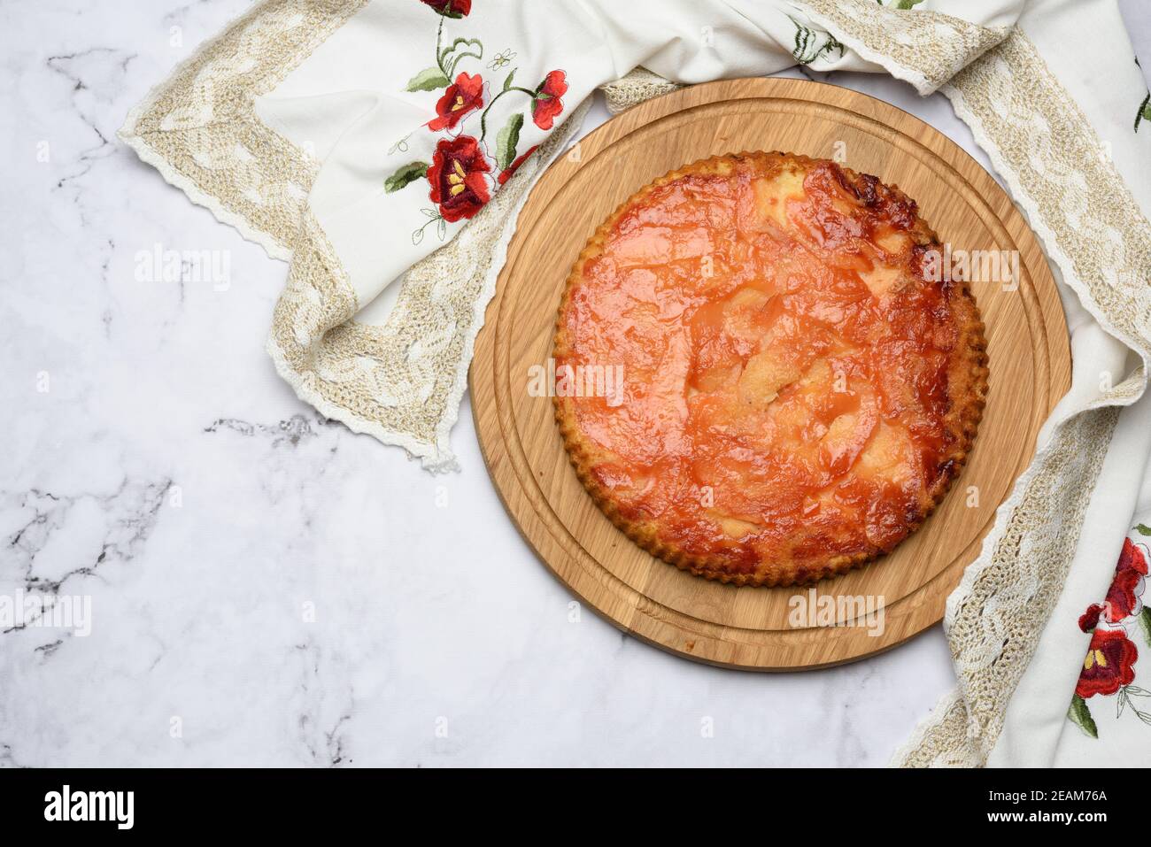 baked round apple pie on wooden board Stock Photo