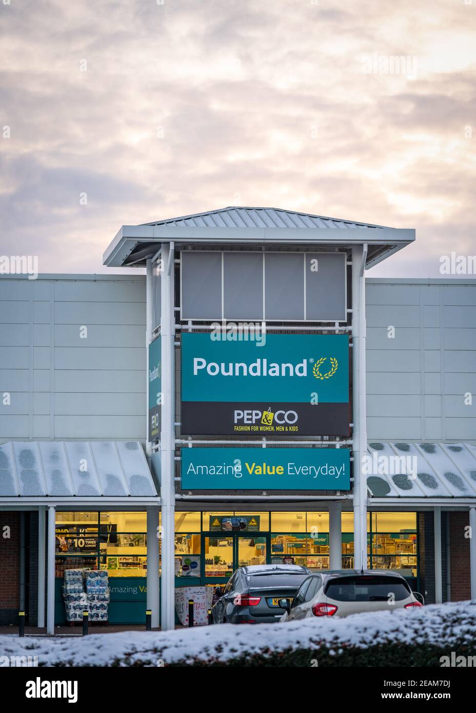Mansfield, Nottingham UK Poundland company Group Ltd retail store front with logo sign and bright cloudy orange sky at sunset Stock Photo