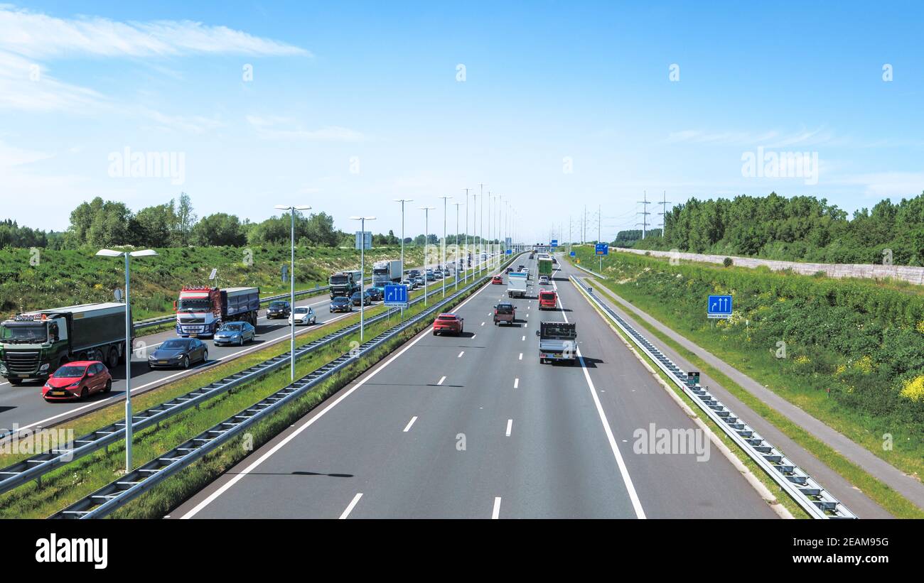 Modern dutch deepened highway A4, afternoon traffic jam direction Rotterdam, Netherlands Stock Photo