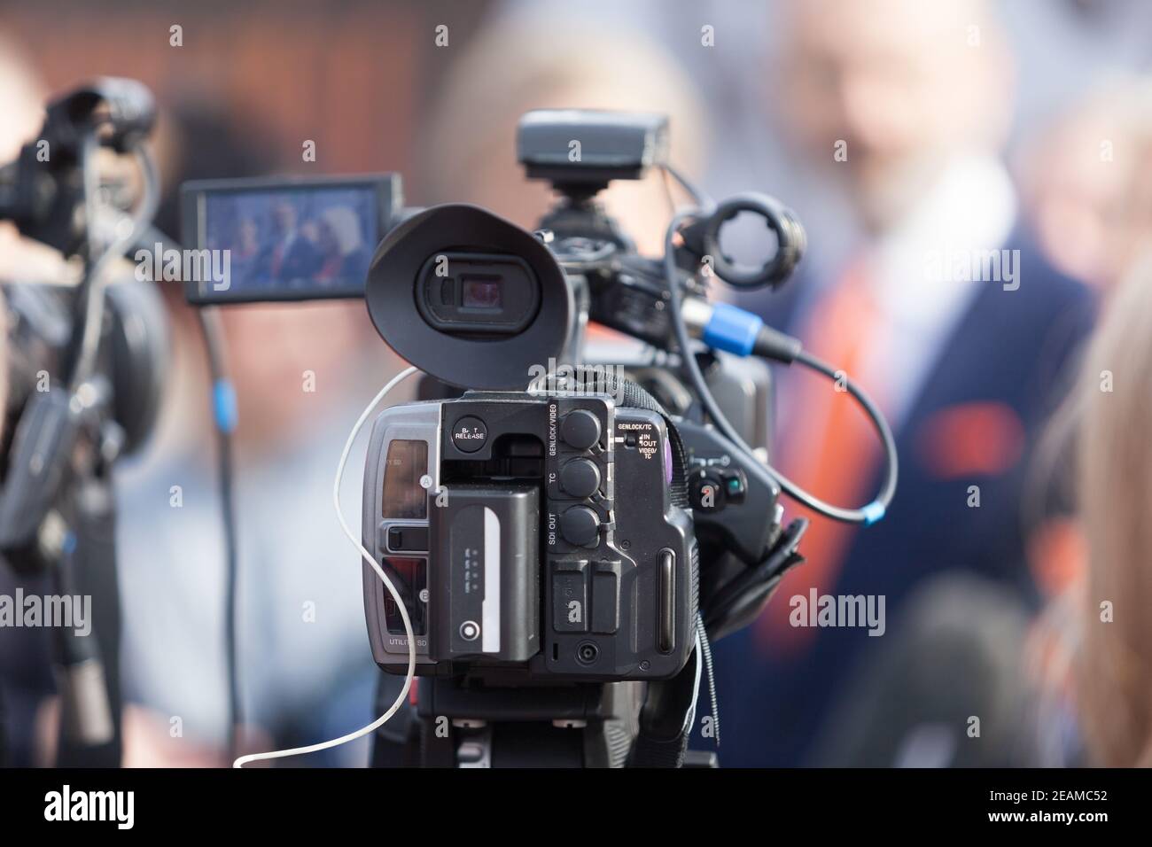 Filming news or press conference with a video camera. Stock Photo