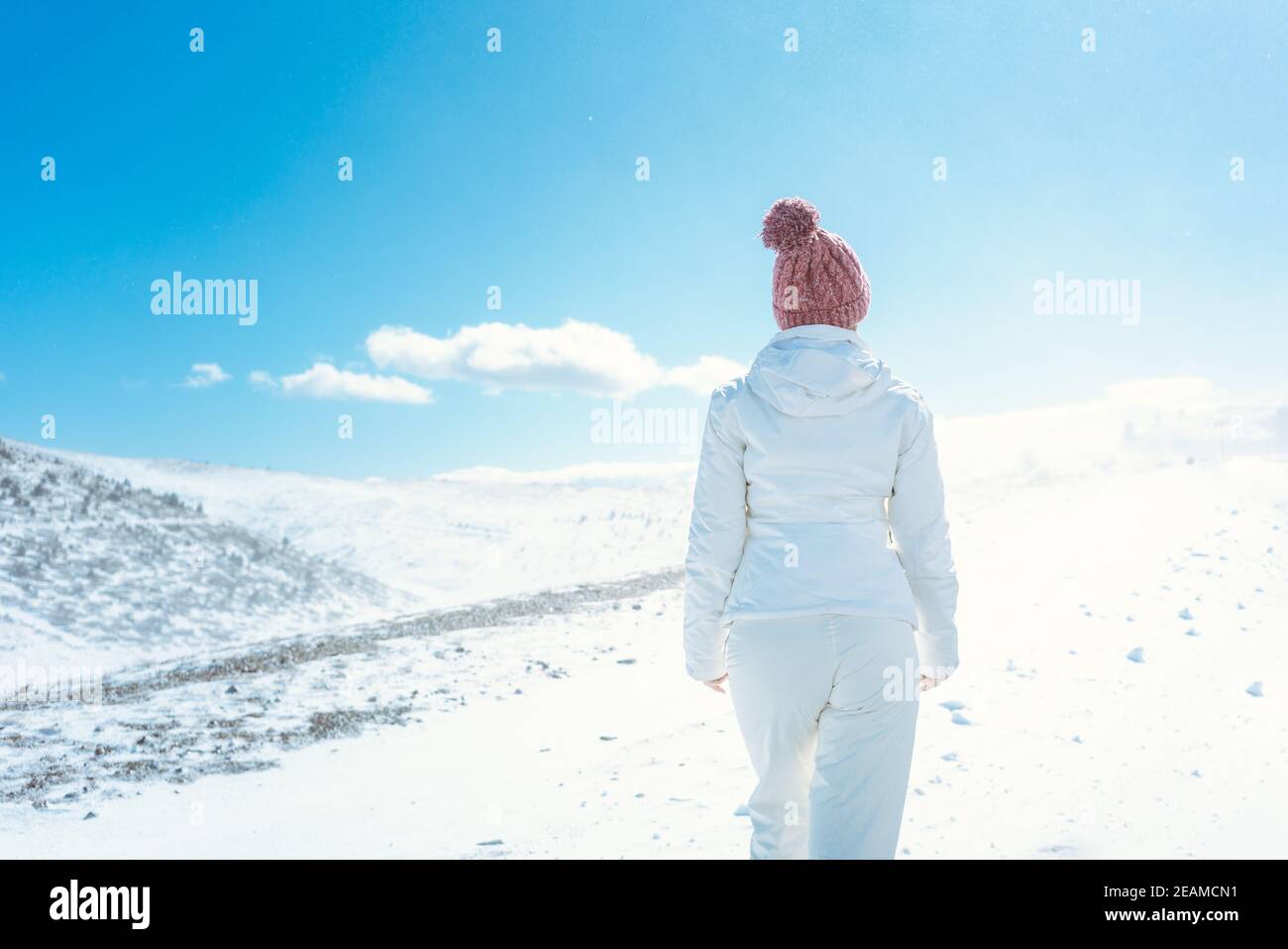 Woman looking at the first snow in the mountains Stock Photo